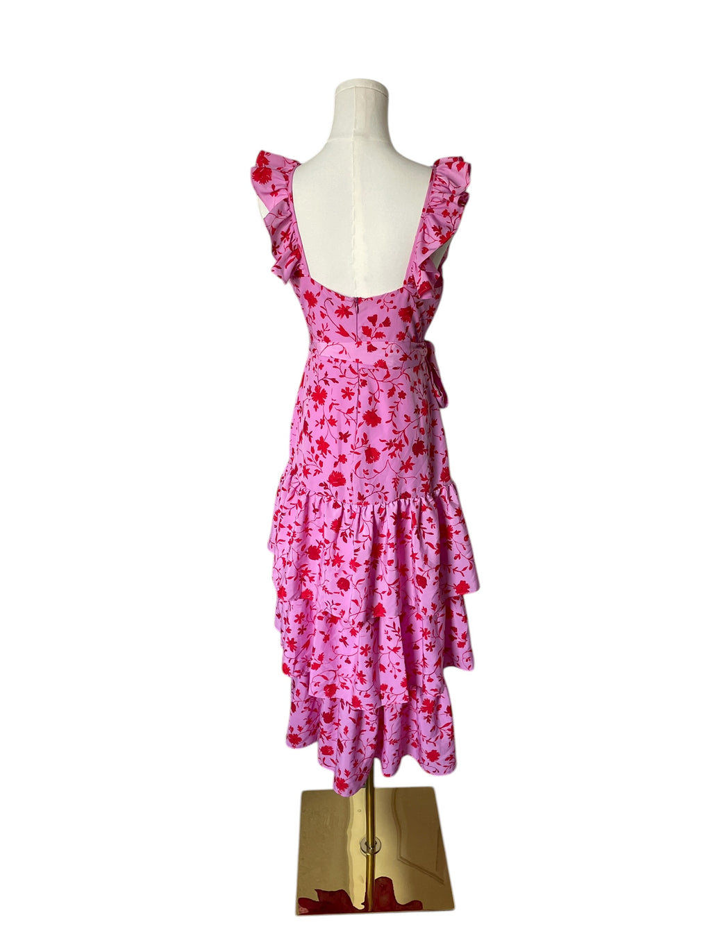 Pink floral dress on a mannequin against a white background