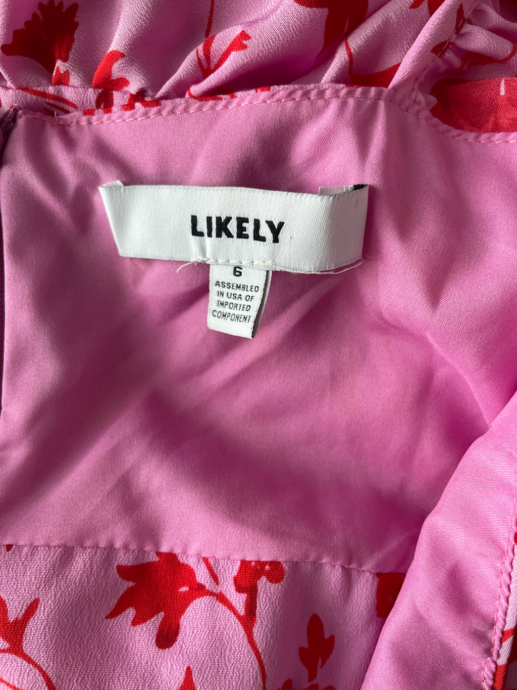 Close-up of a pink garment with a 'LIKELY' label.
