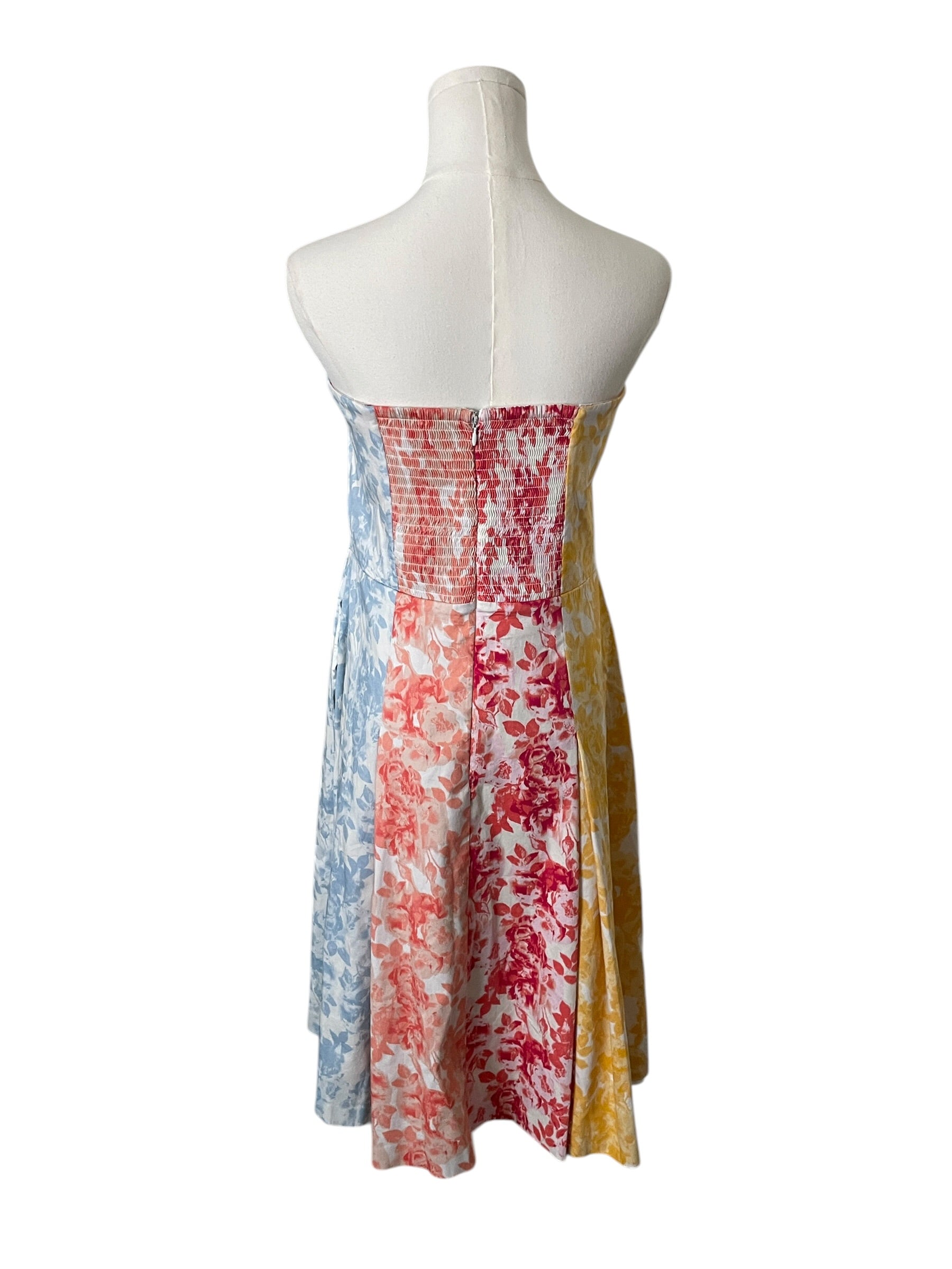 Colorful dress on a mannequin against a white background