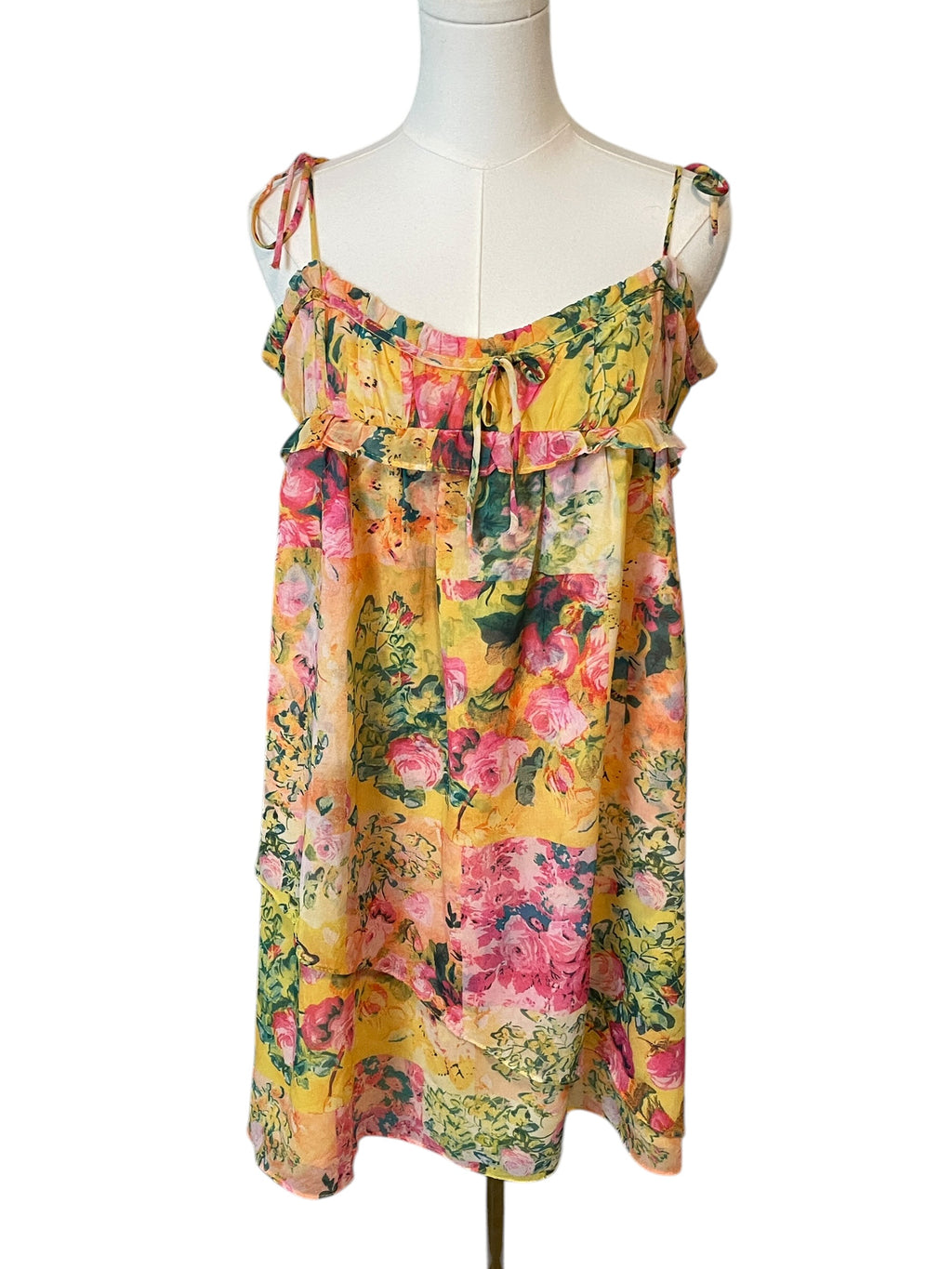 Floral dress on a mannequin against a white background