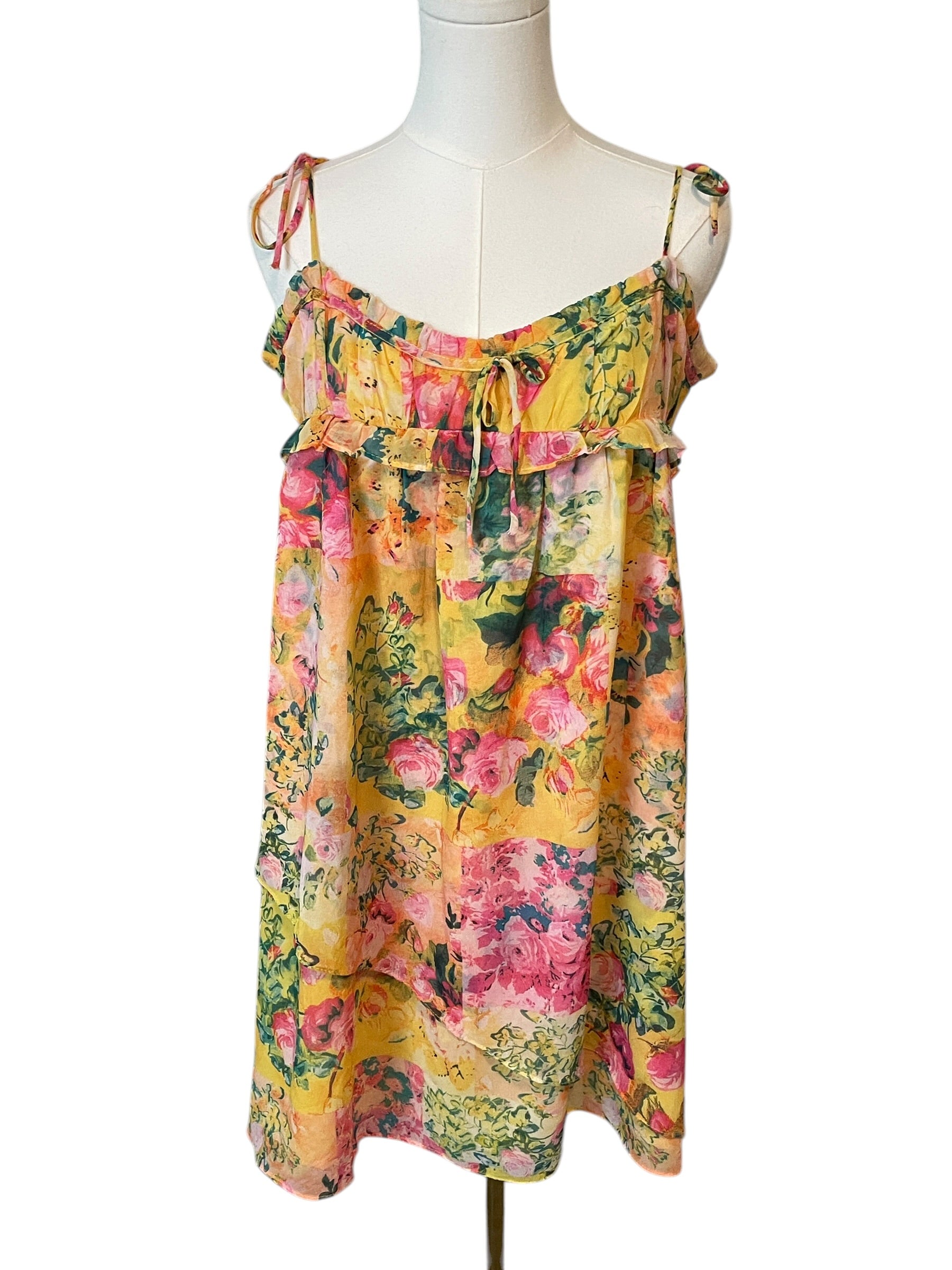 Floral dress on a mannequin against a white background