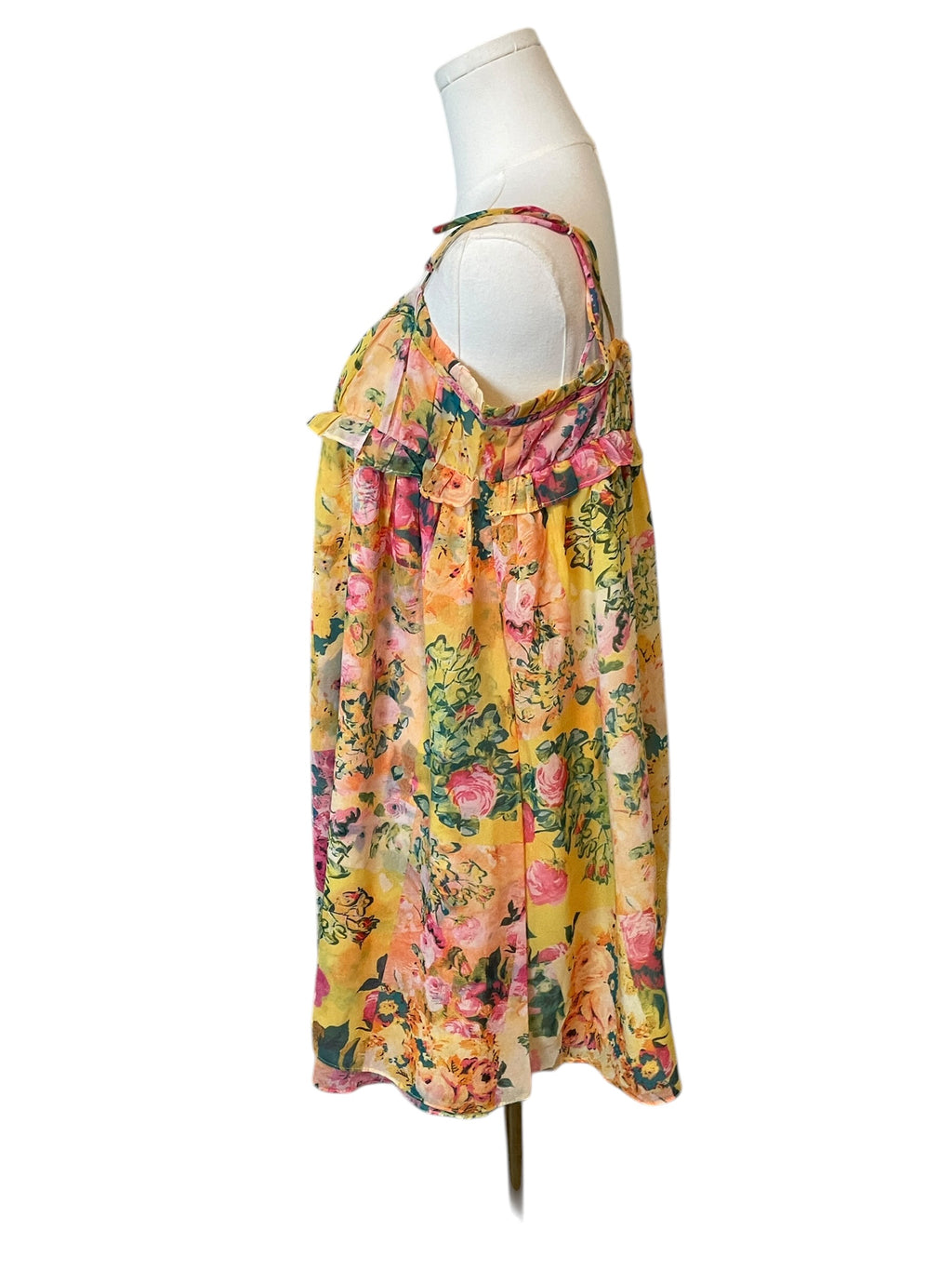 Floral dress on a mannequin against a white background