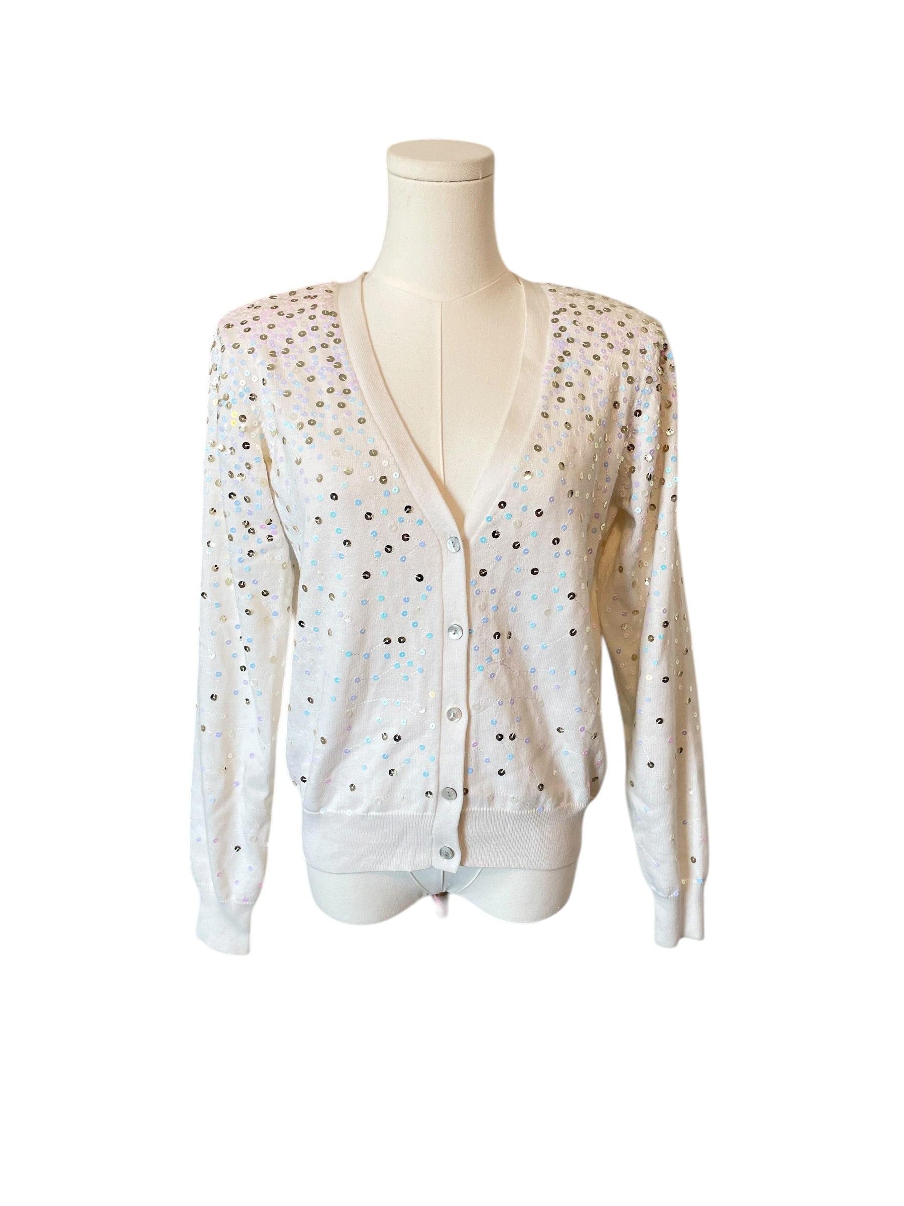 White cardigan with small patterns on a mannequin against a white background