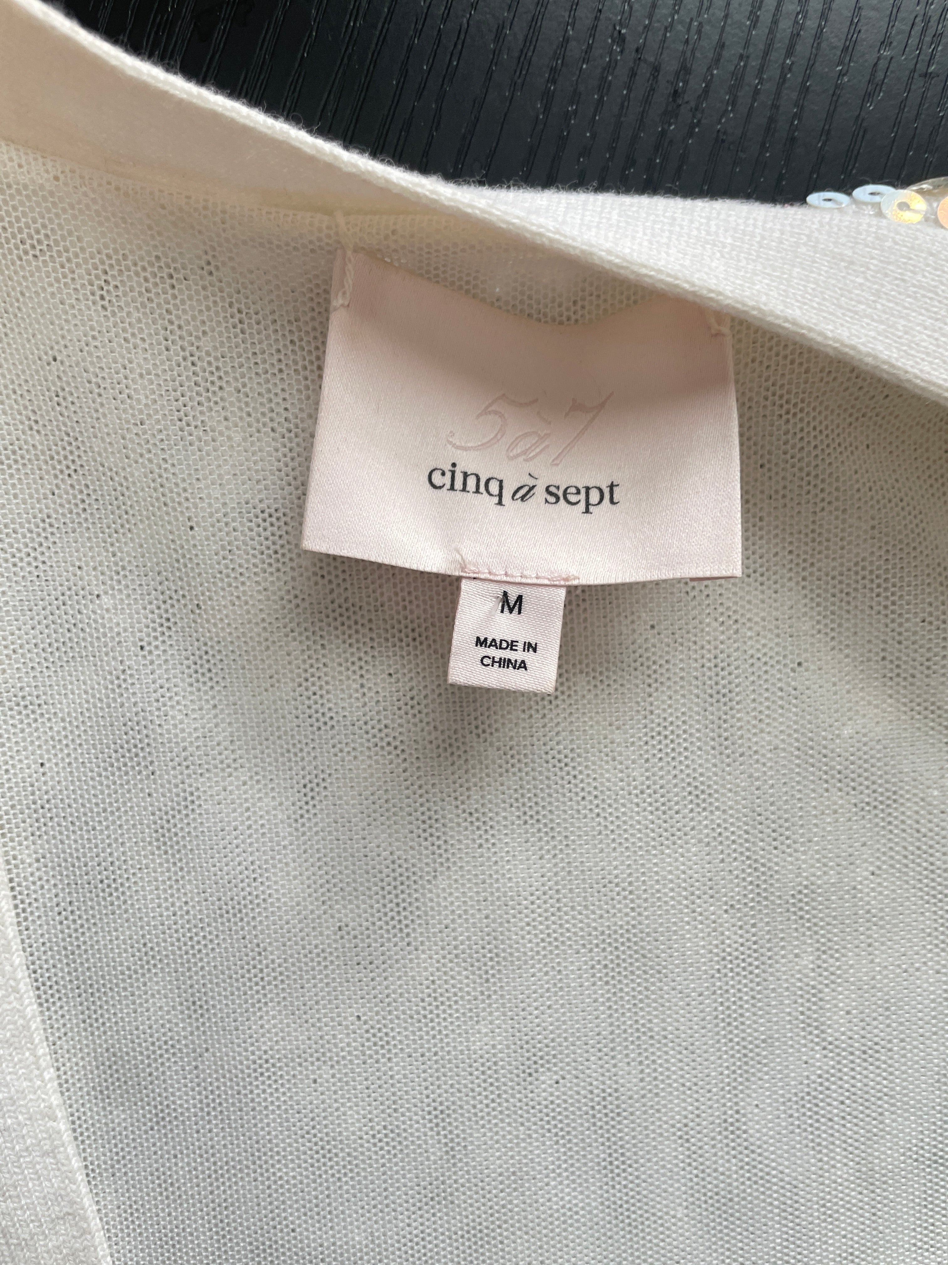 Clothing label with 'cliq sept' brand on a light gray fabric background