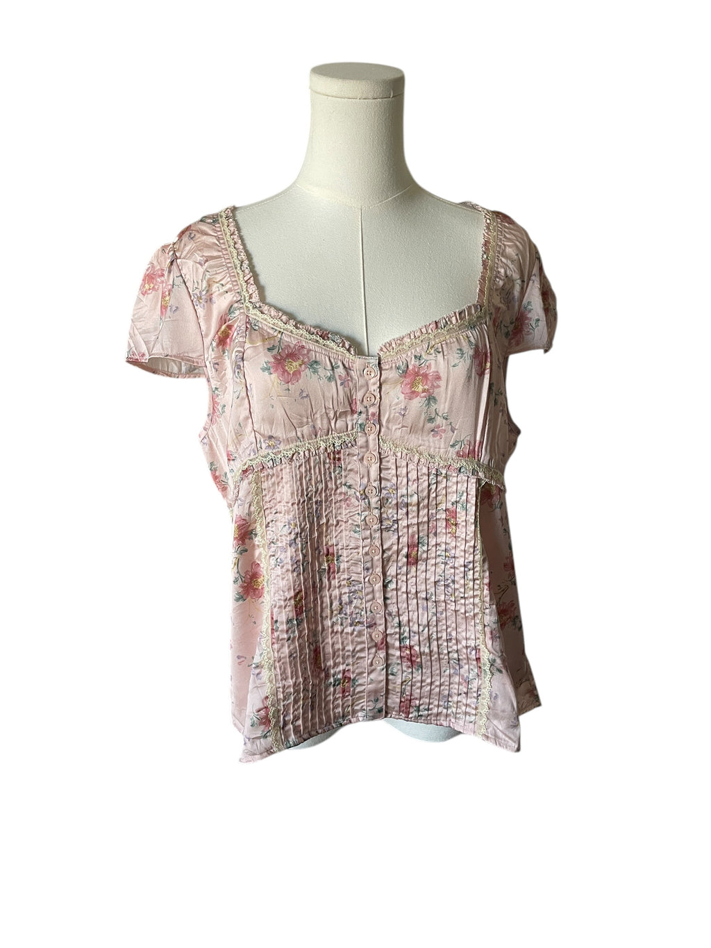 Floral patterned top on a mannequin against a white background