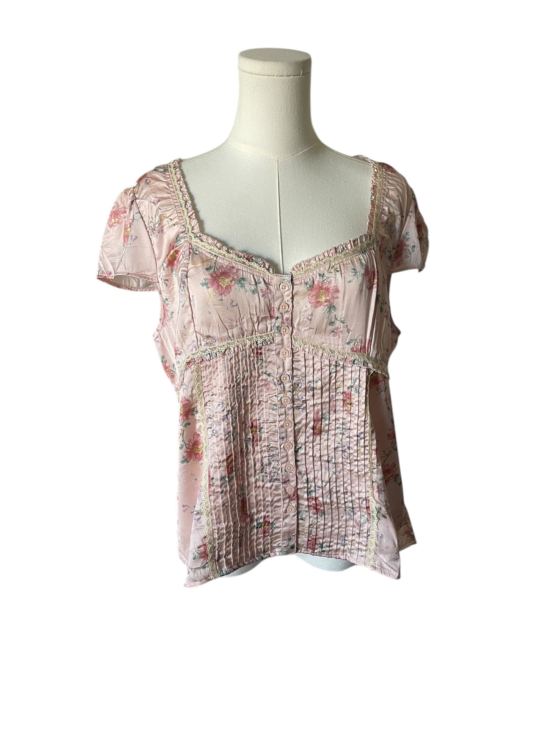 Floral patterned top on a mannequin against a white background
