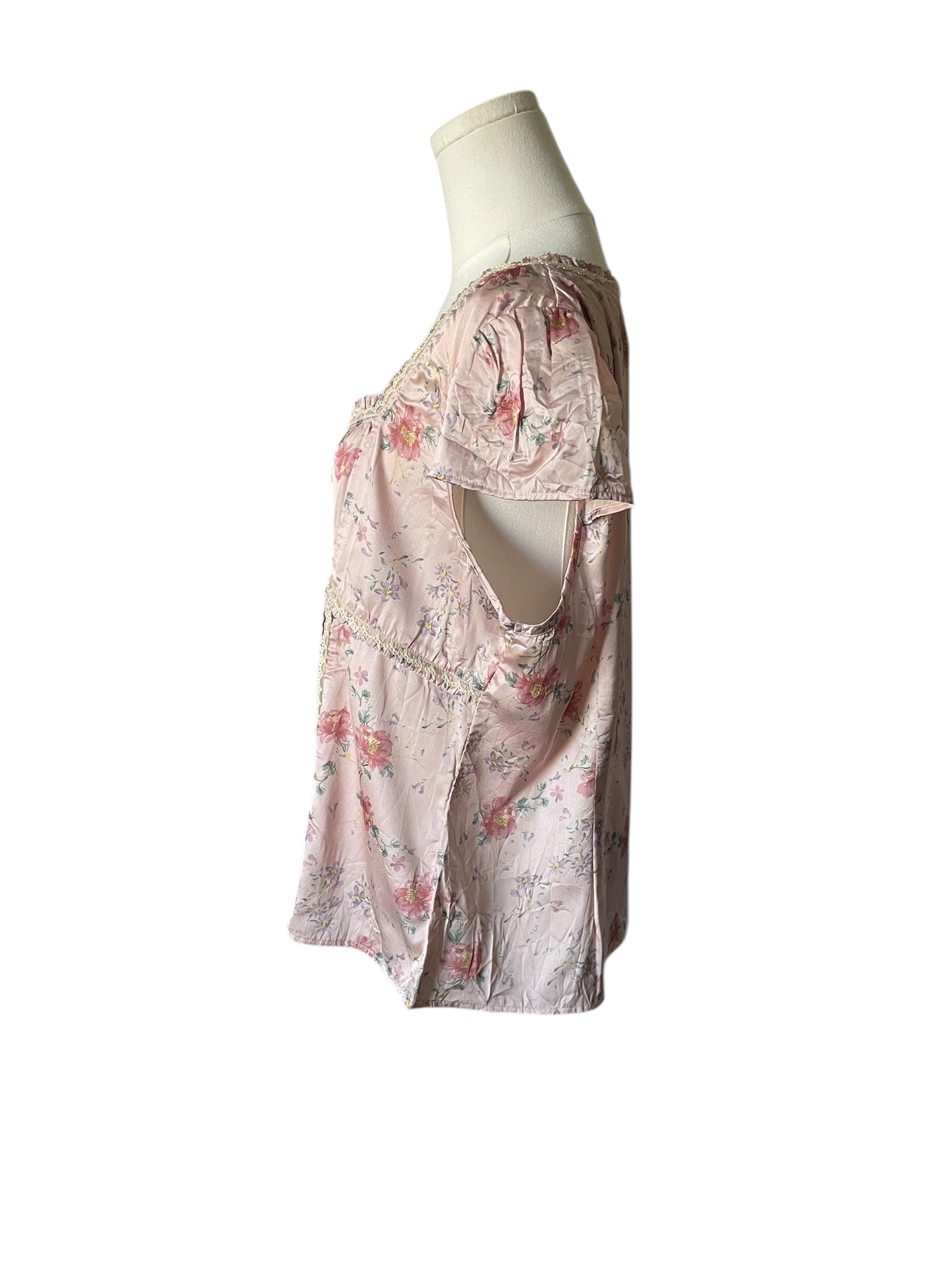 Floral dress on a mannequin against a white background