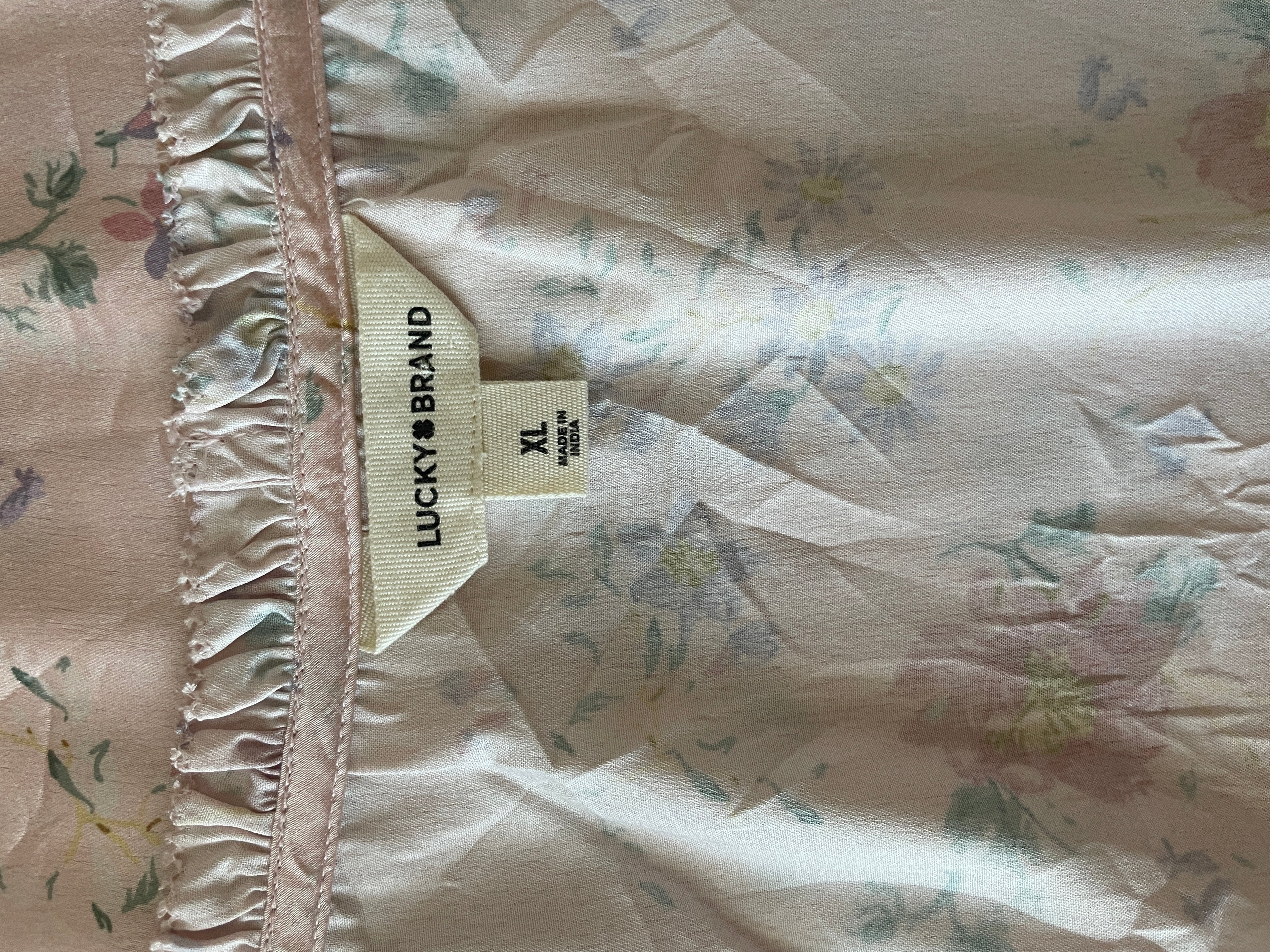 Floral-patterned fabric with a 'Lucky Brand' tag visible