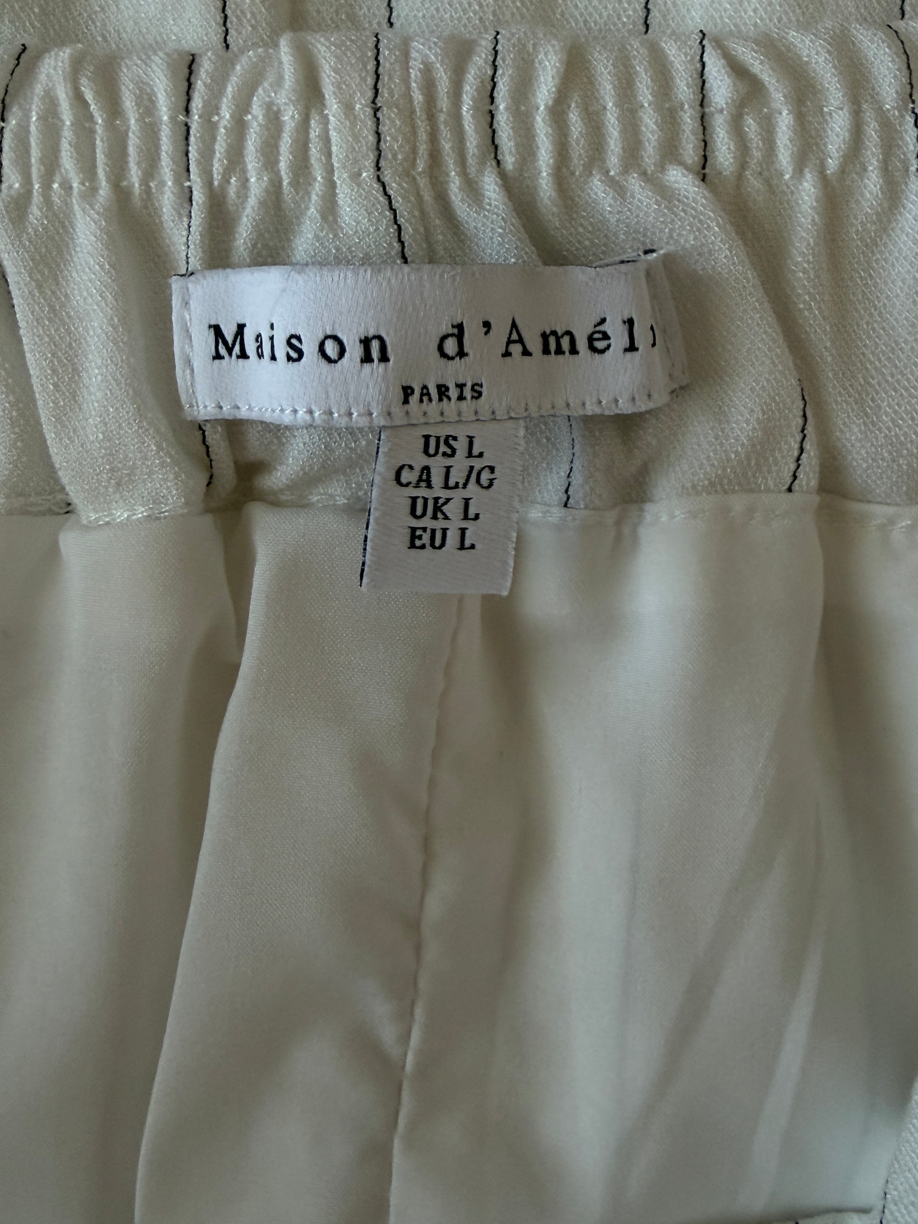 Close-up of a beige fabric with a 'Maison d'Amelie' label.