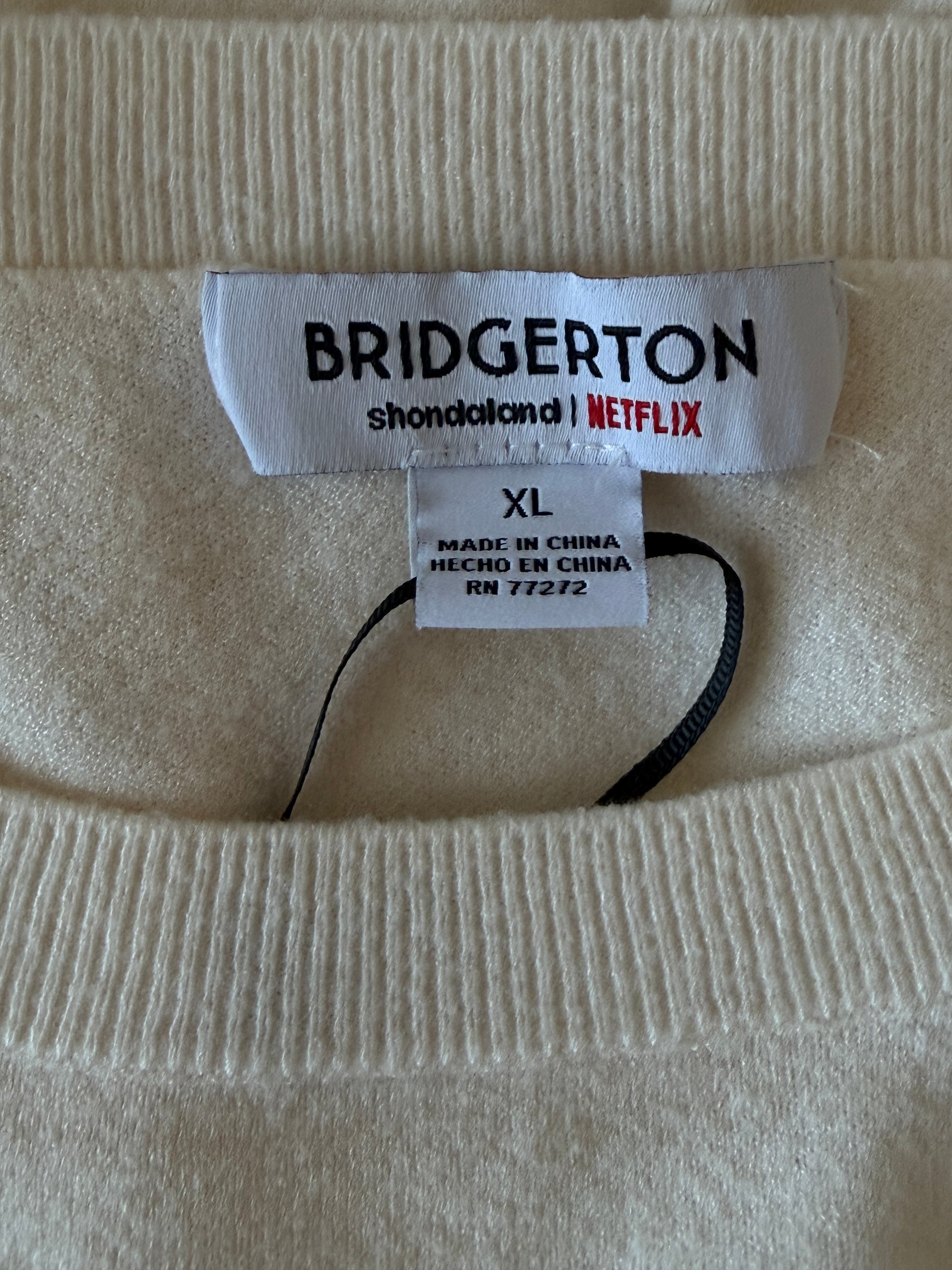 Close-up of a Bridgerton branded tag on a beige fabric background