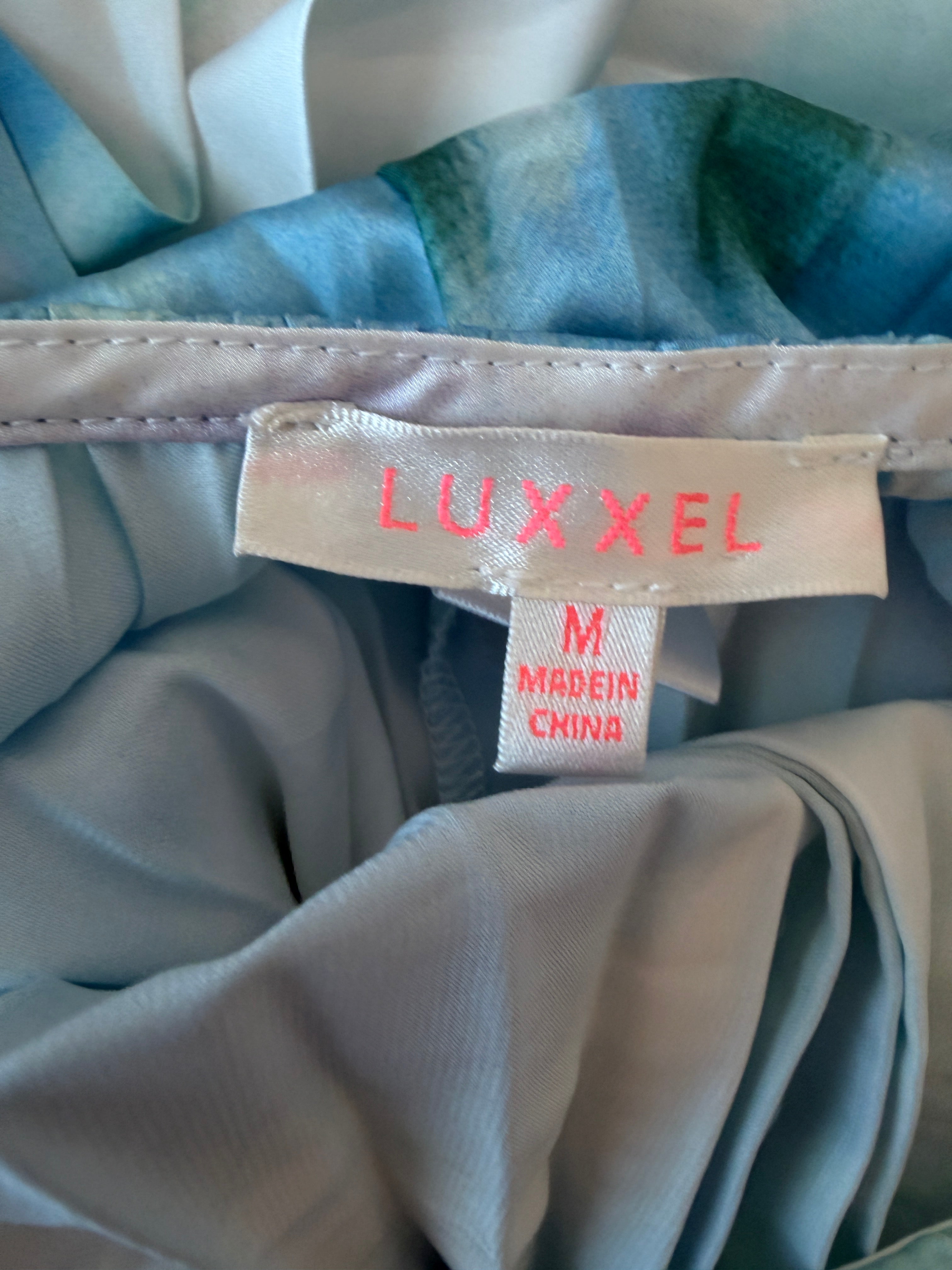 Luxcel label on a piece of fabric with a blurred background