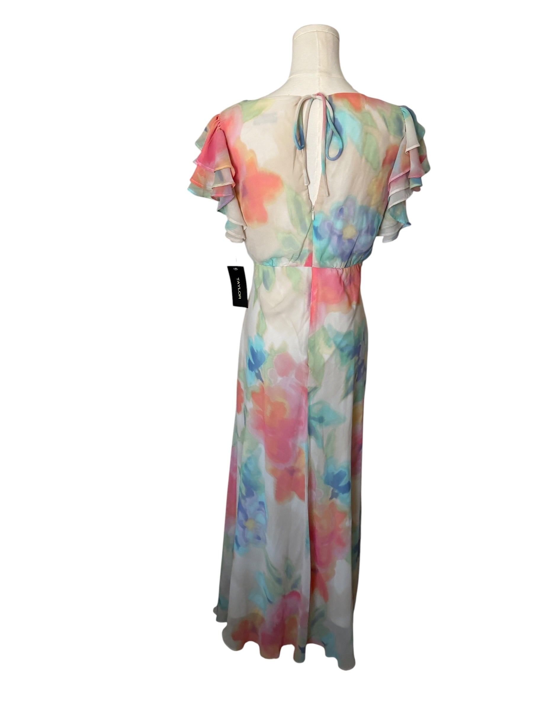 Colorful floral dress on a mannequin against a white background