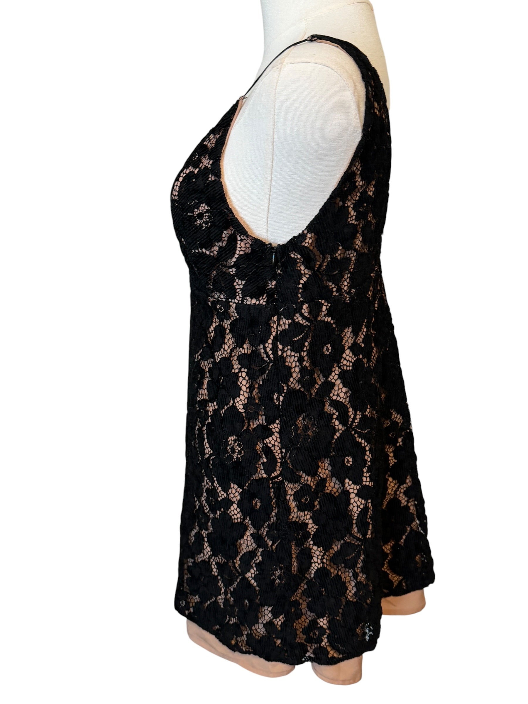 Black lace dress on a mannequin against a white background
