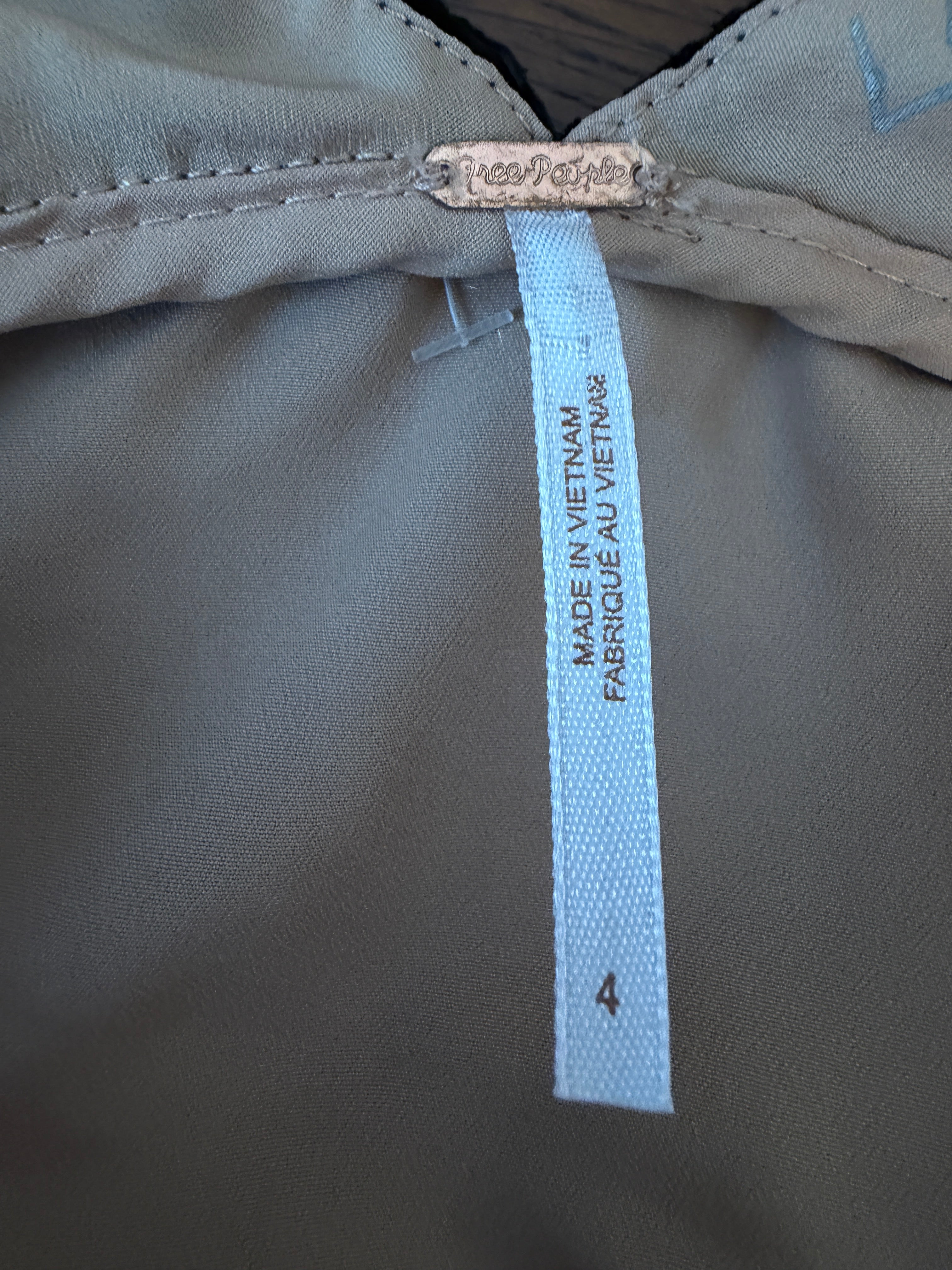 Close-up of a label on a gray fabric surface with 'Made in Vietnam' text.