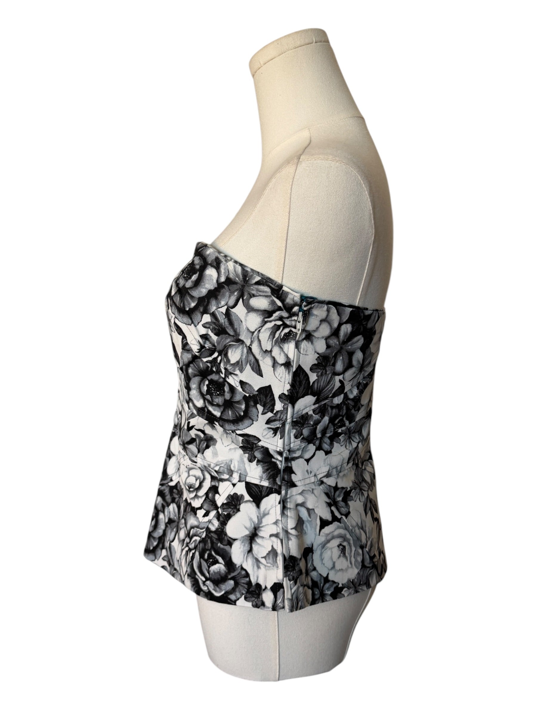 Black floral strapless top on a mannequin against a white background
