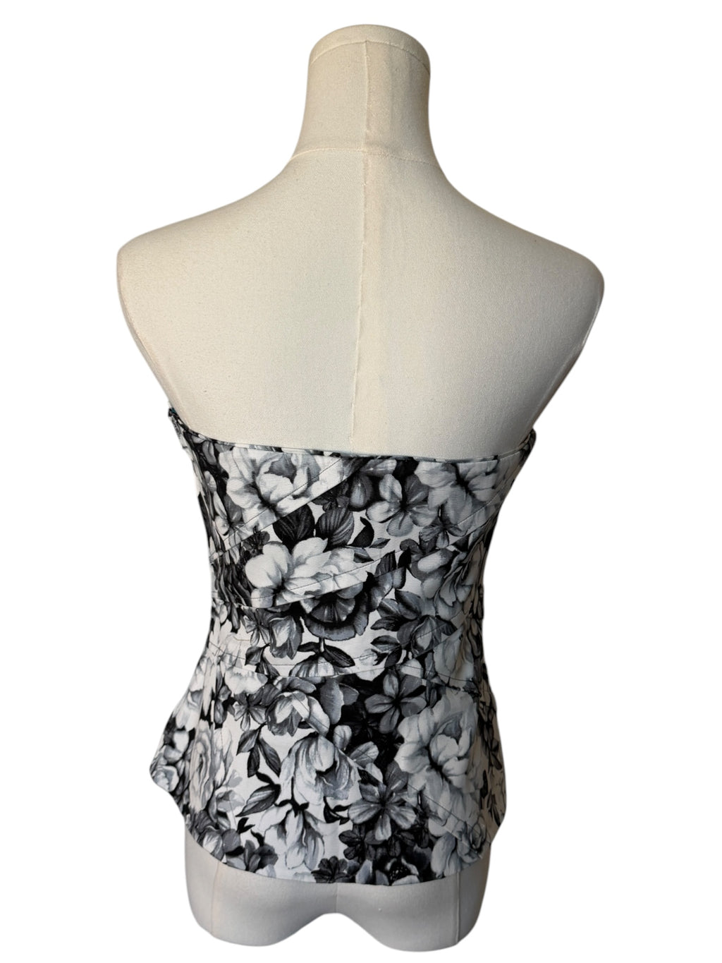 Black and white floral strapless top on a mannequin against a white background