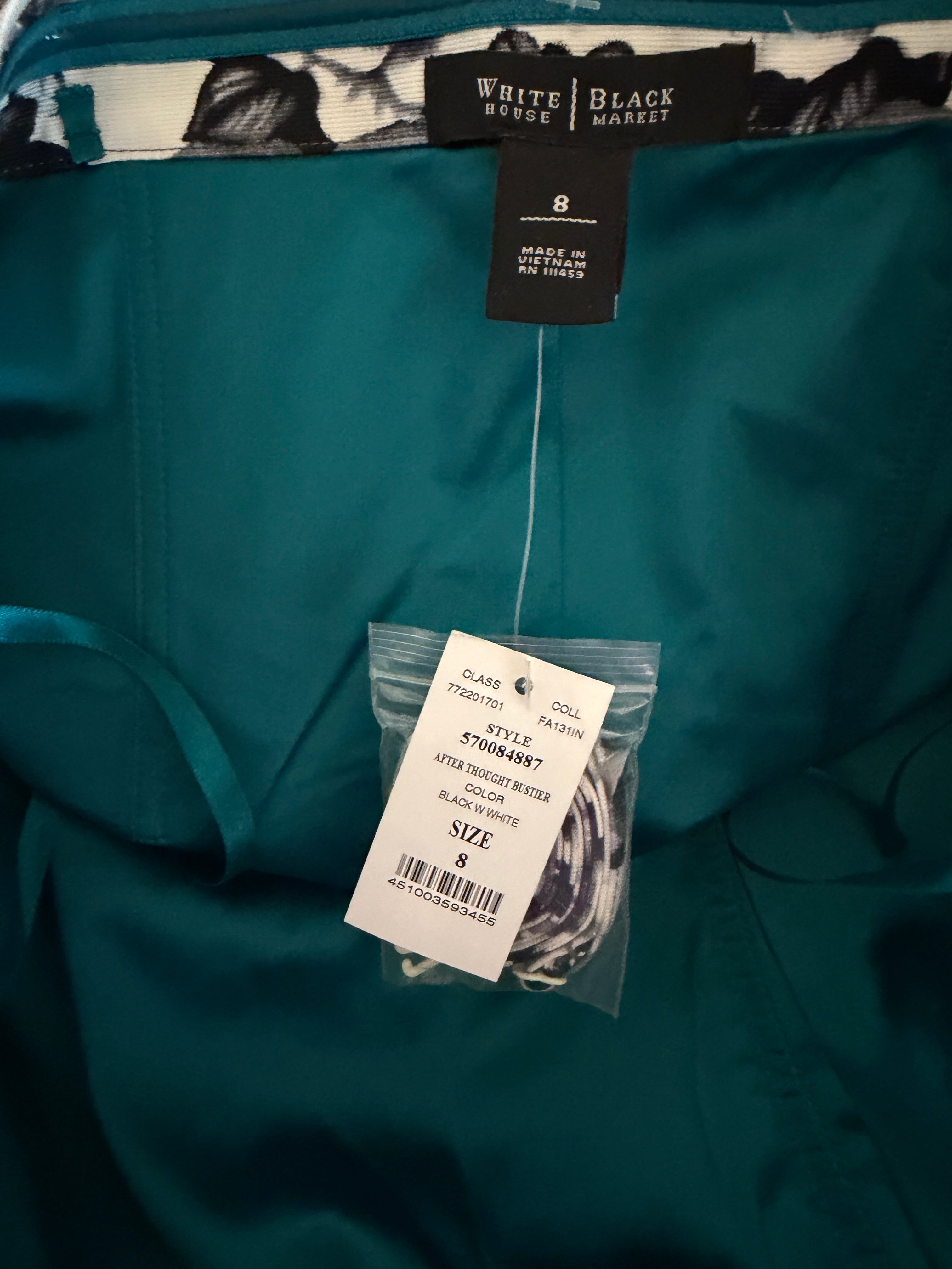 Teal shirt with tags from White Black Market and a label on a dark background