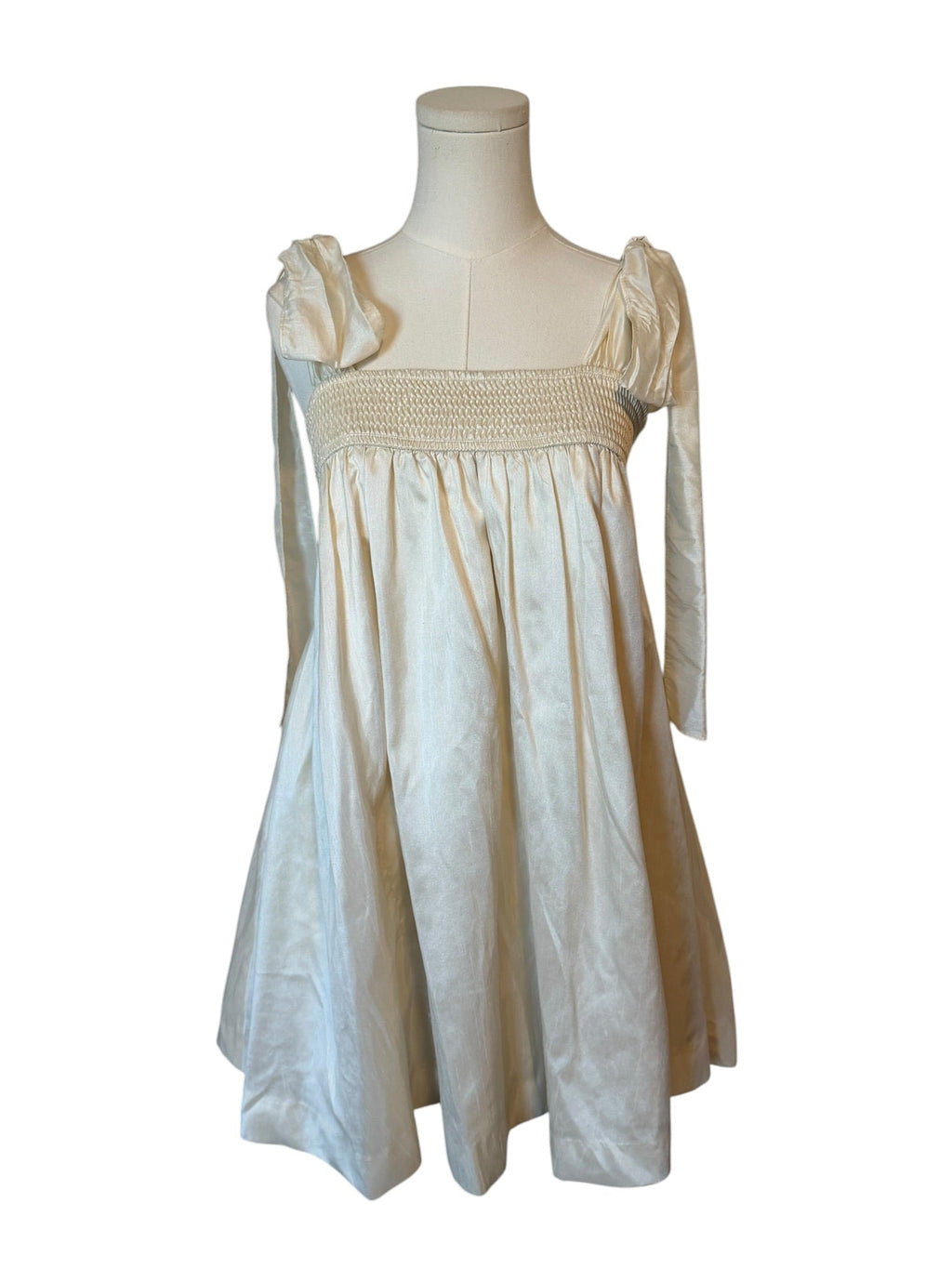 White dress on a mannequin against a white background
