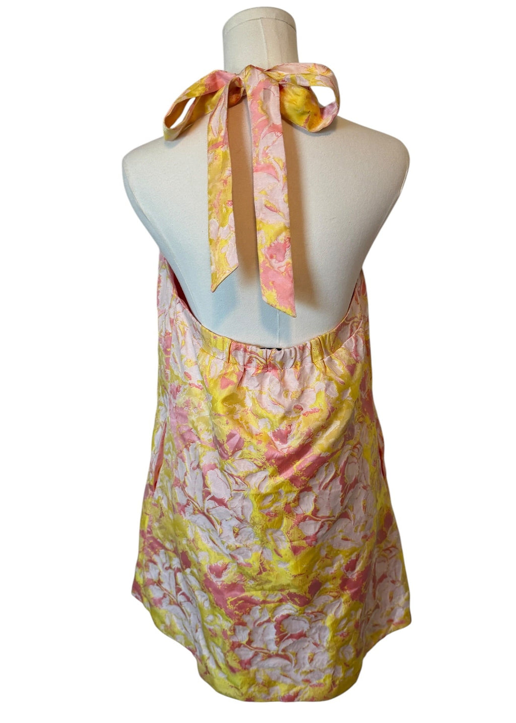 Floral halter top on a mannequin against a white background