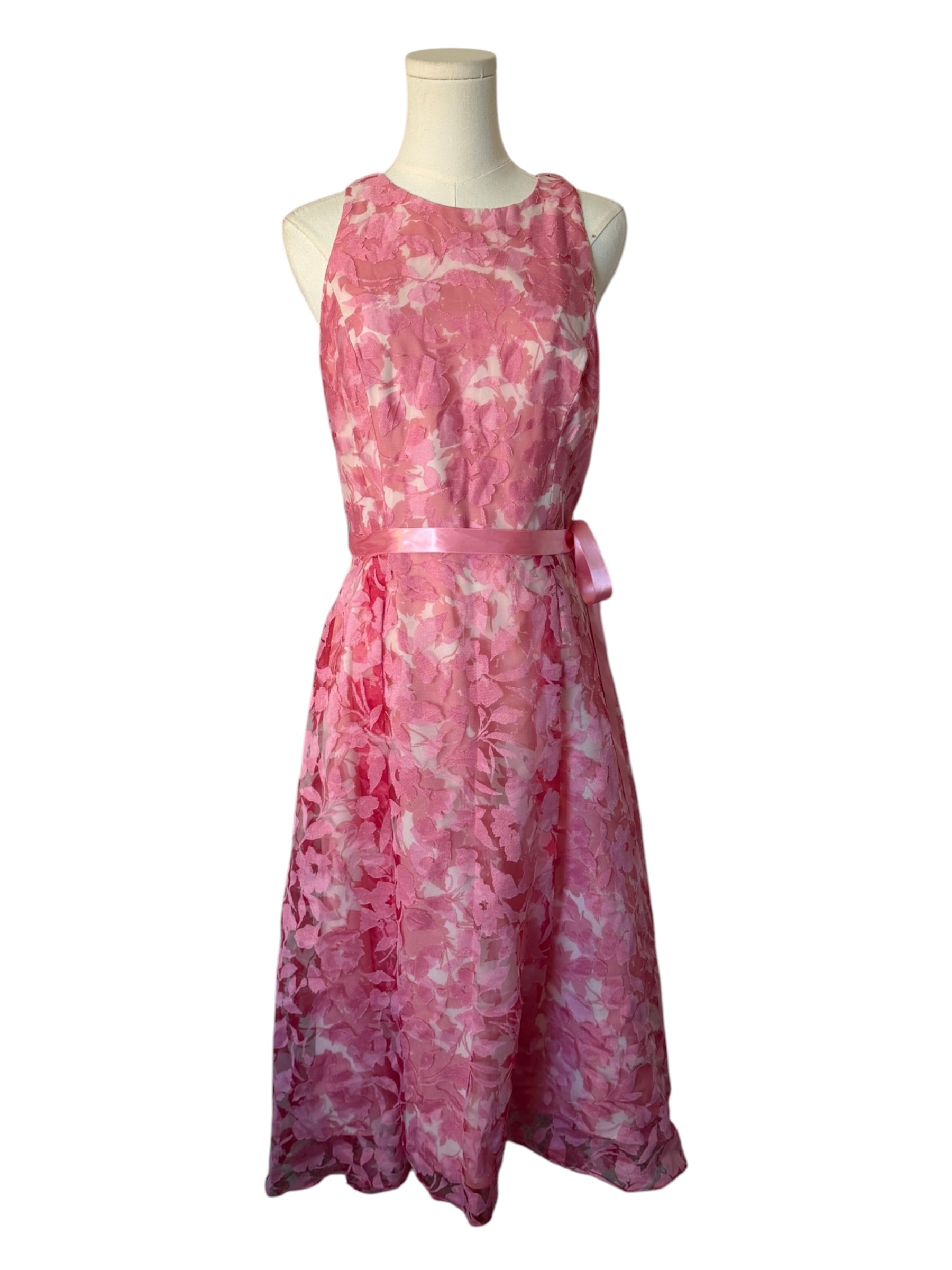Pink floral dress on a mannequin against a white background