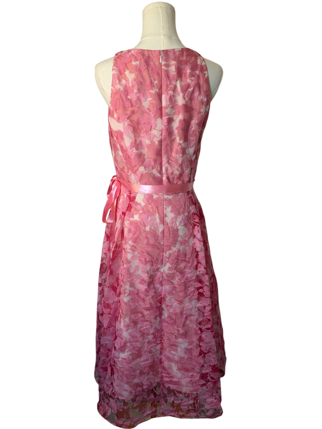 Pink floral dress on a mannequin against a white background
