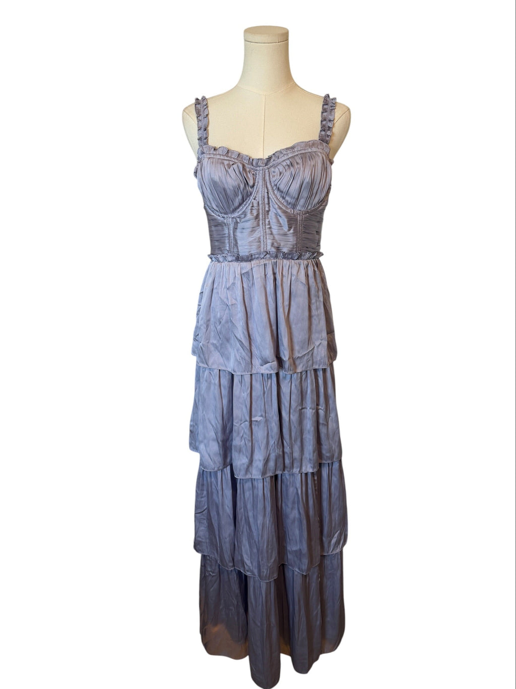 Blue tiered dress on a mannequin against a white background