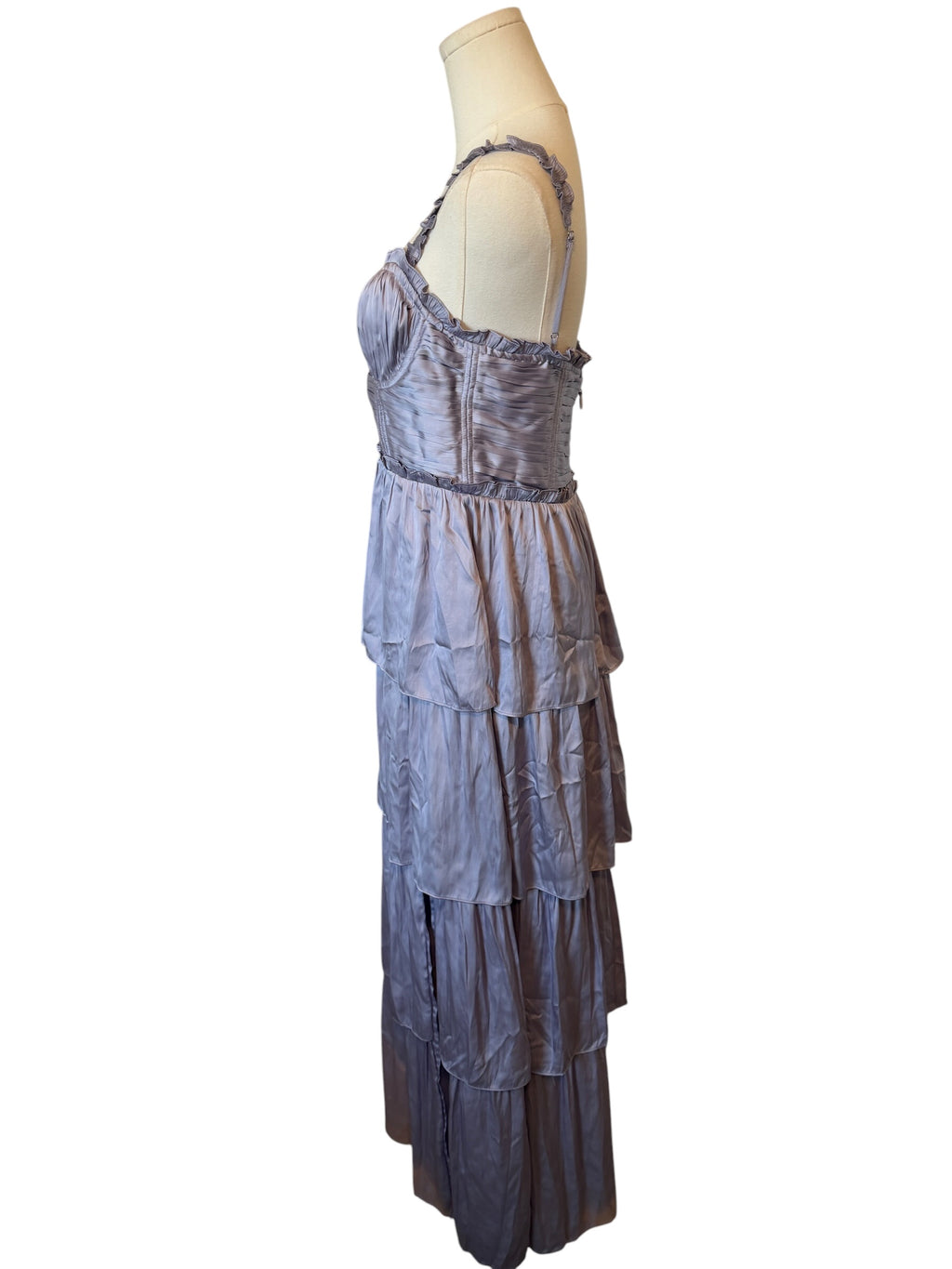 Purple tiered dress on a mannequin against a white background