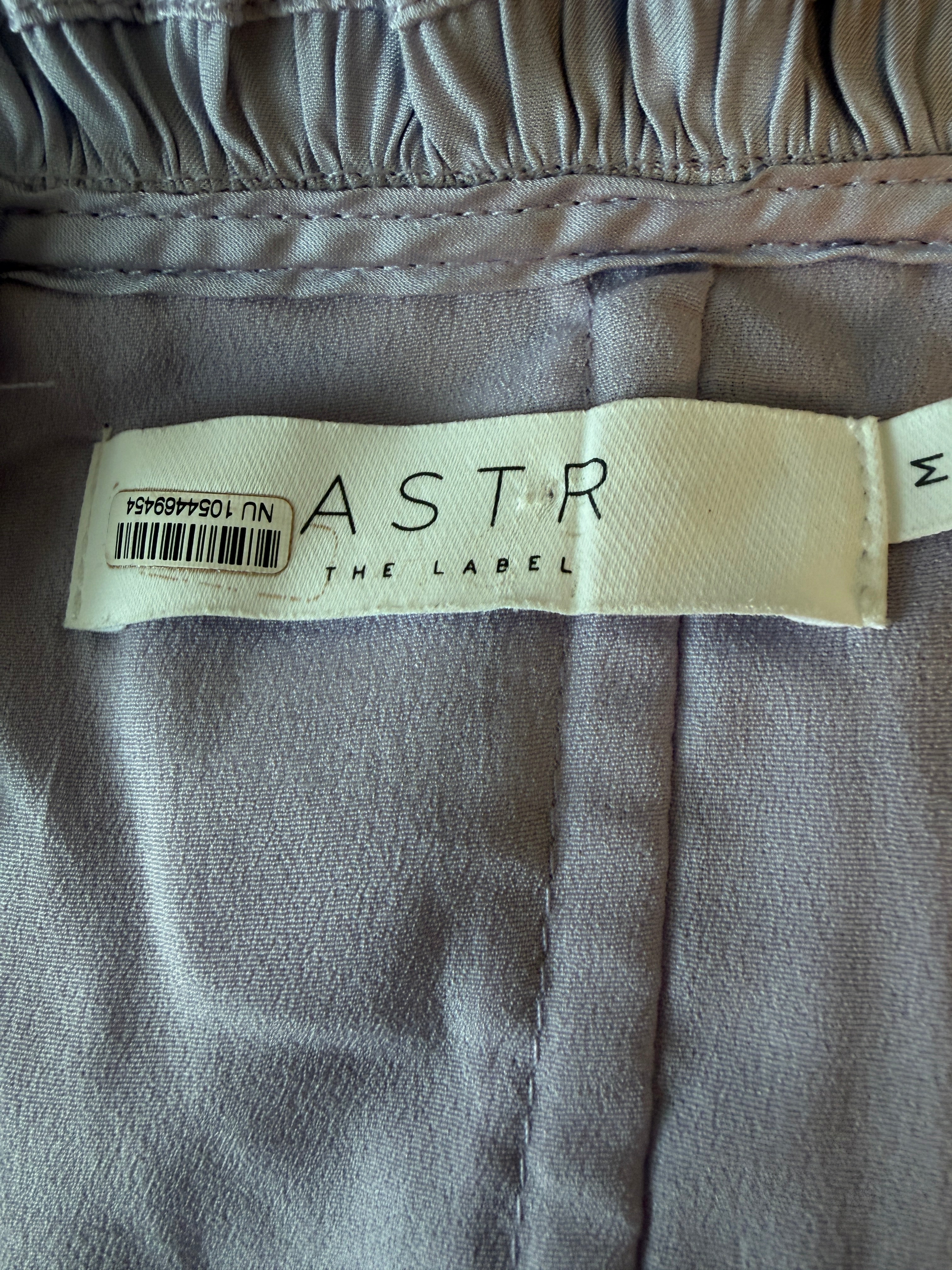 Label on a piece of gray fabric with 'Astor The Label' branding.