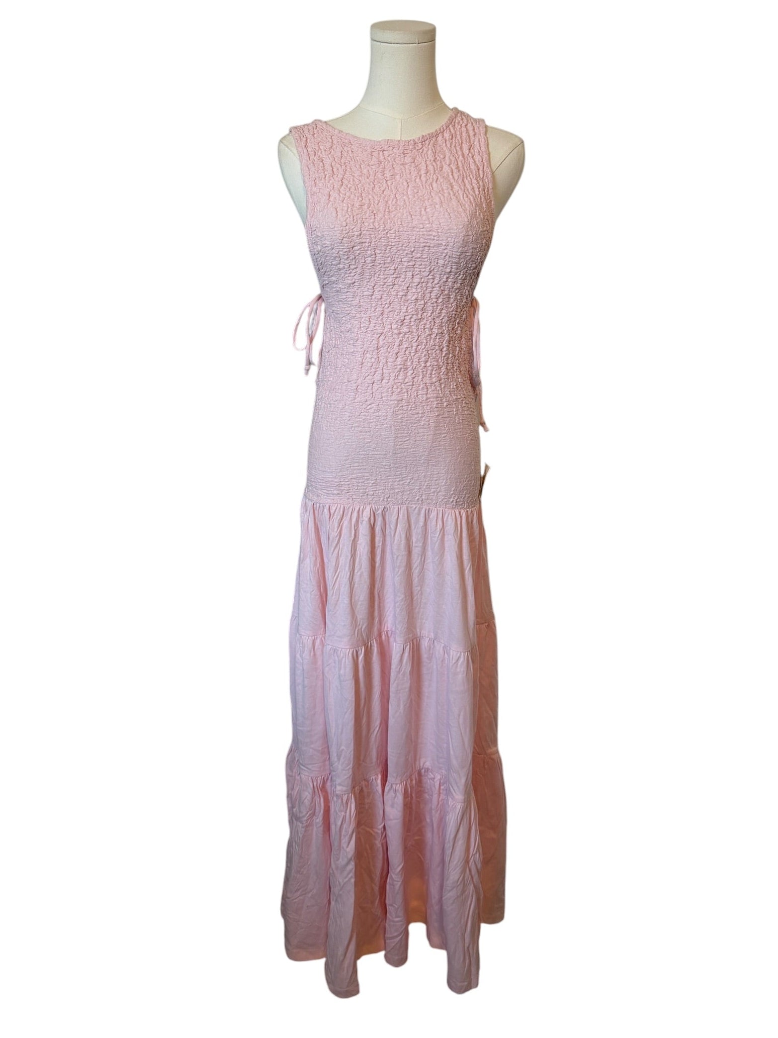 Pink dress on a mannequin against a white background