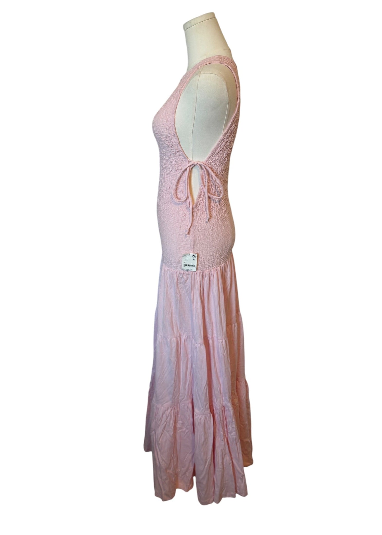 Pink dress on a mannequin against a white background