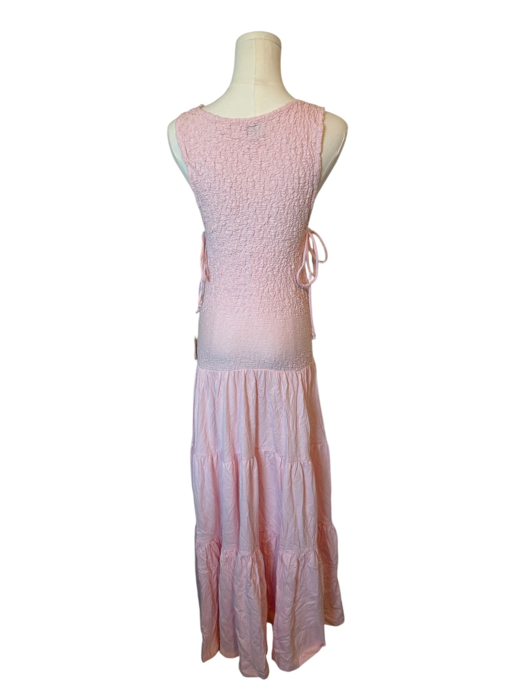 Pink dress on a mannequin against a white background