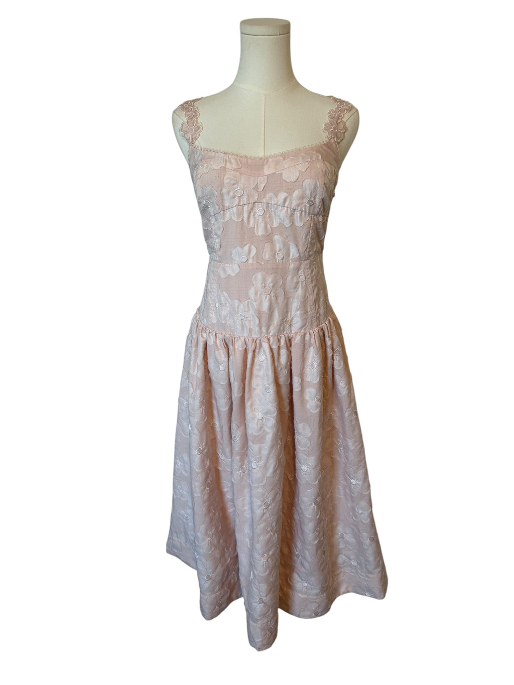 Lace dress on a mannequin against a white background