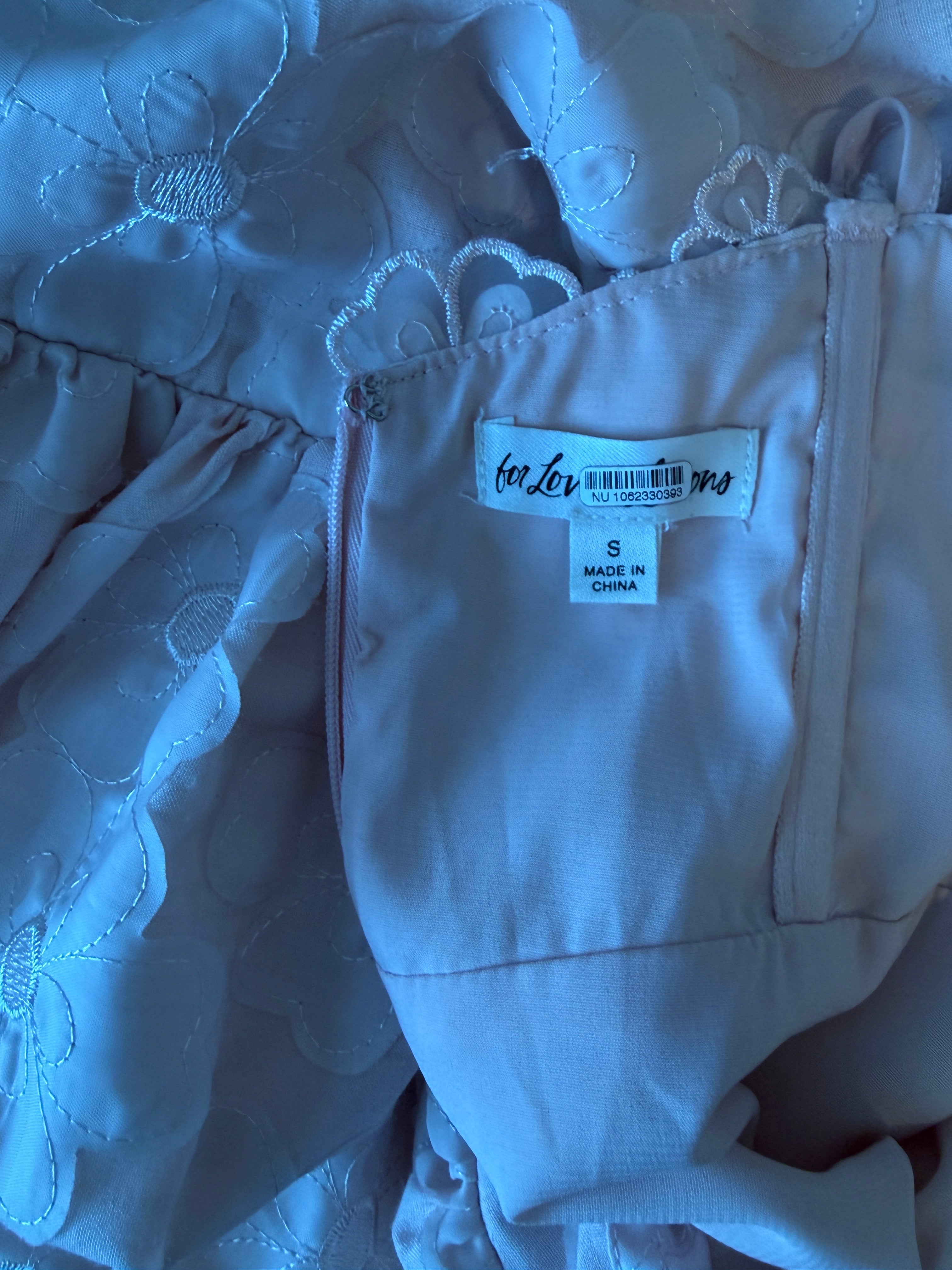 Close-up of a garment with a label on a textured surface