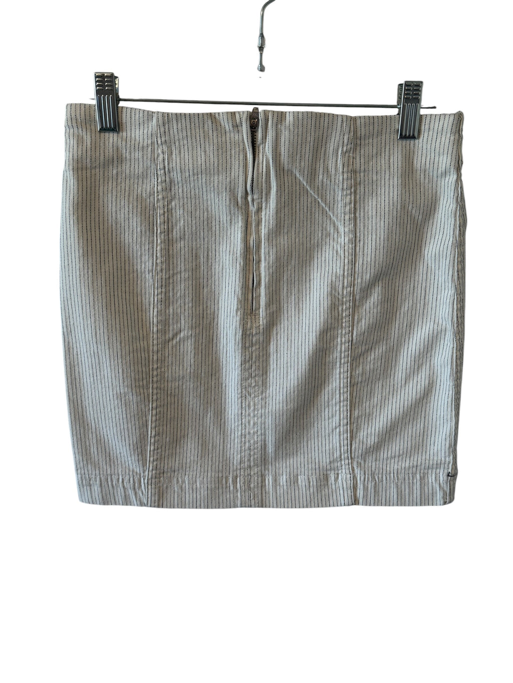 Striped skirt hanging on a rack with clips against a white background