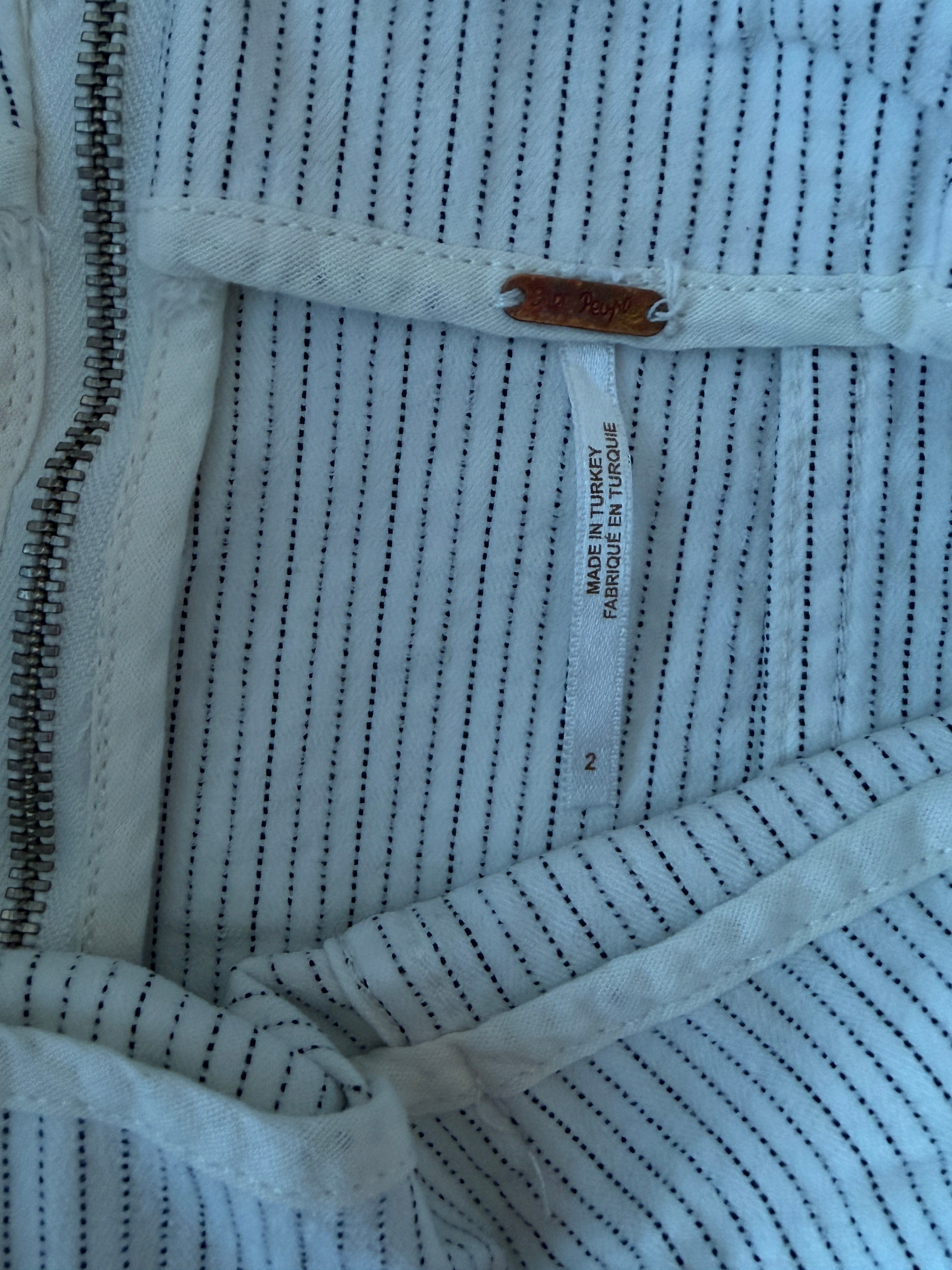 Close-up of a textured fabric with a zipper and label.
