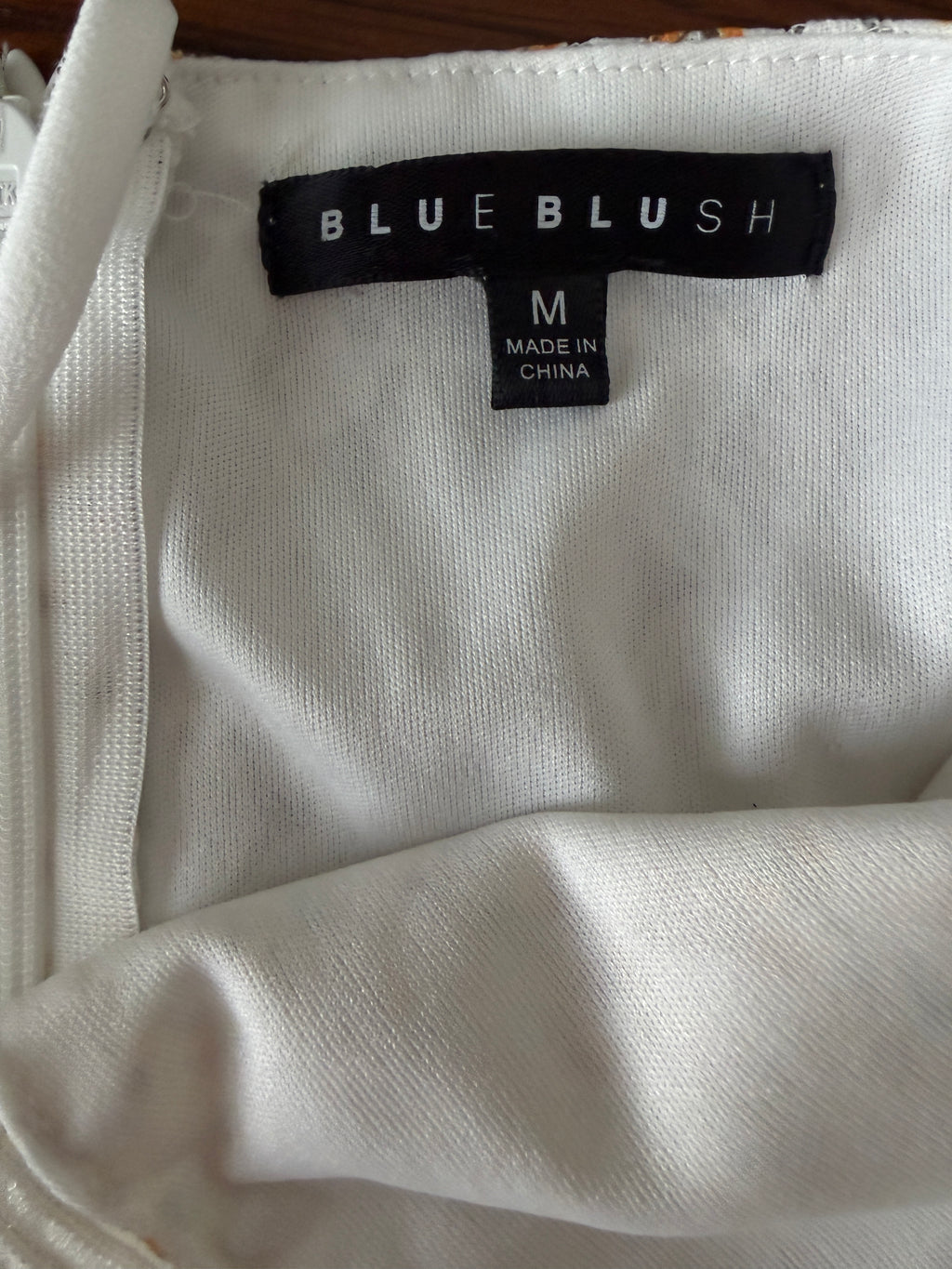 White garment with a 'Blue Blush' label on a white background