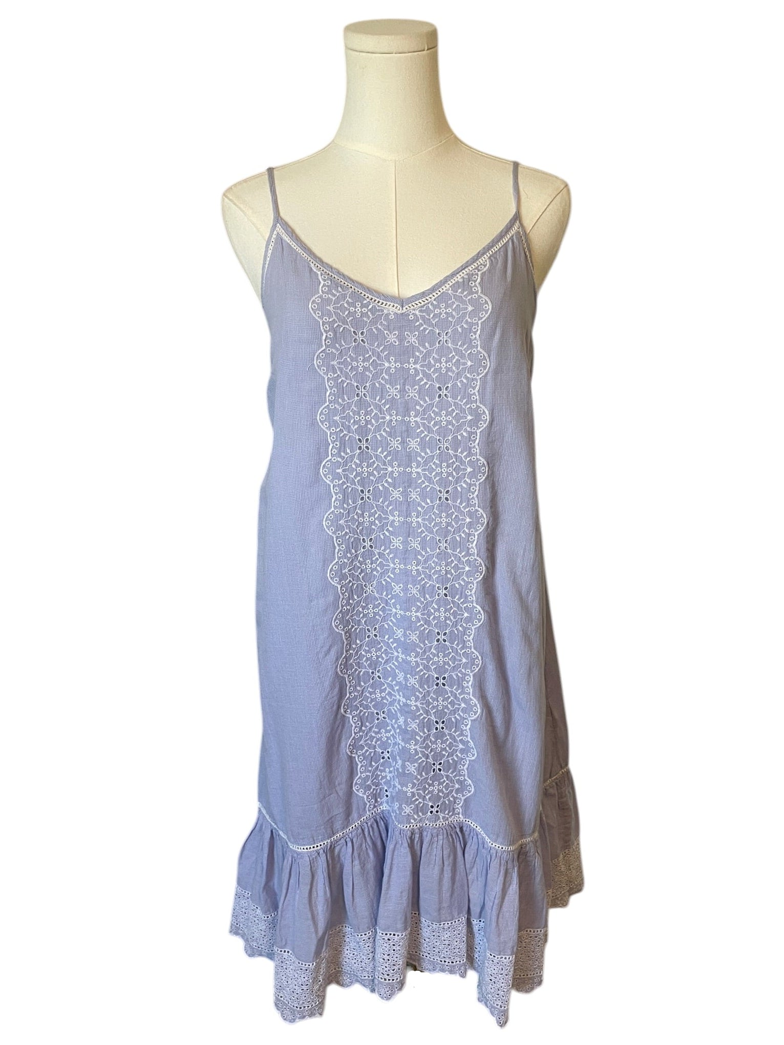 Light blue slip dress with lace details on a mannequin against a white background