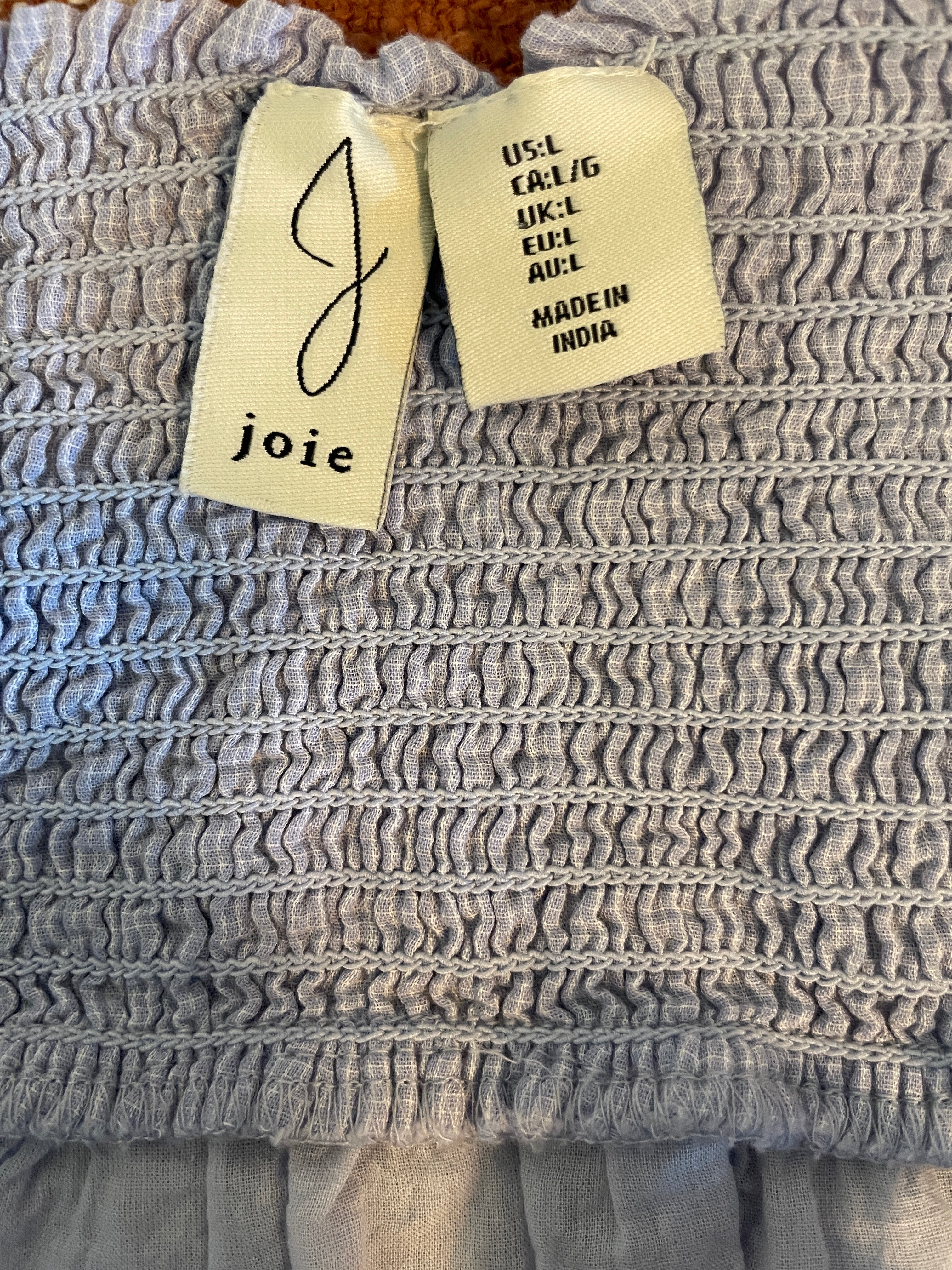 Textile product with 'joie' brand tag and 'Made in India' label.