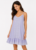 Woman wearing a light purple slip dress with lace details on a white background