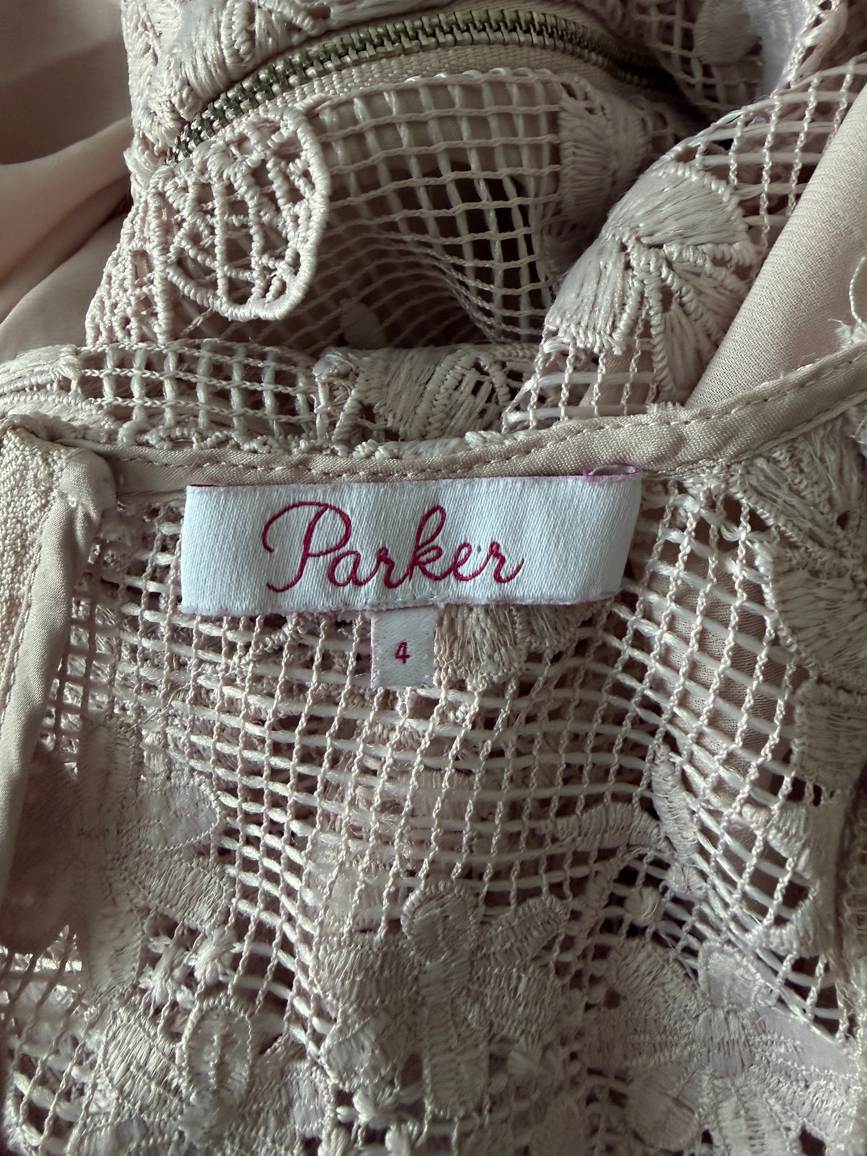 Close-up of lace fabric with a 'Parker' label.