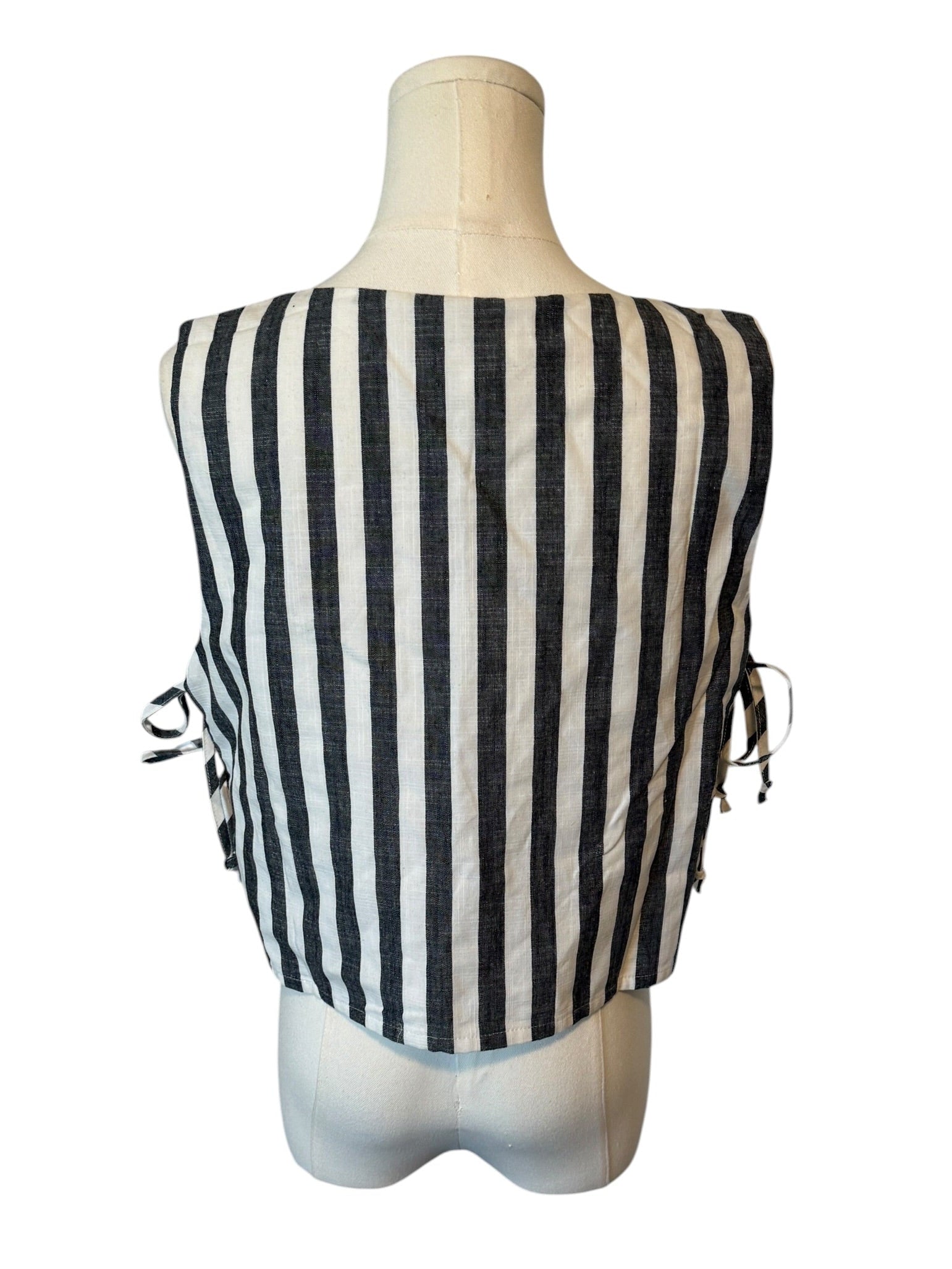 Black and white striped top on a mannequin against a white background