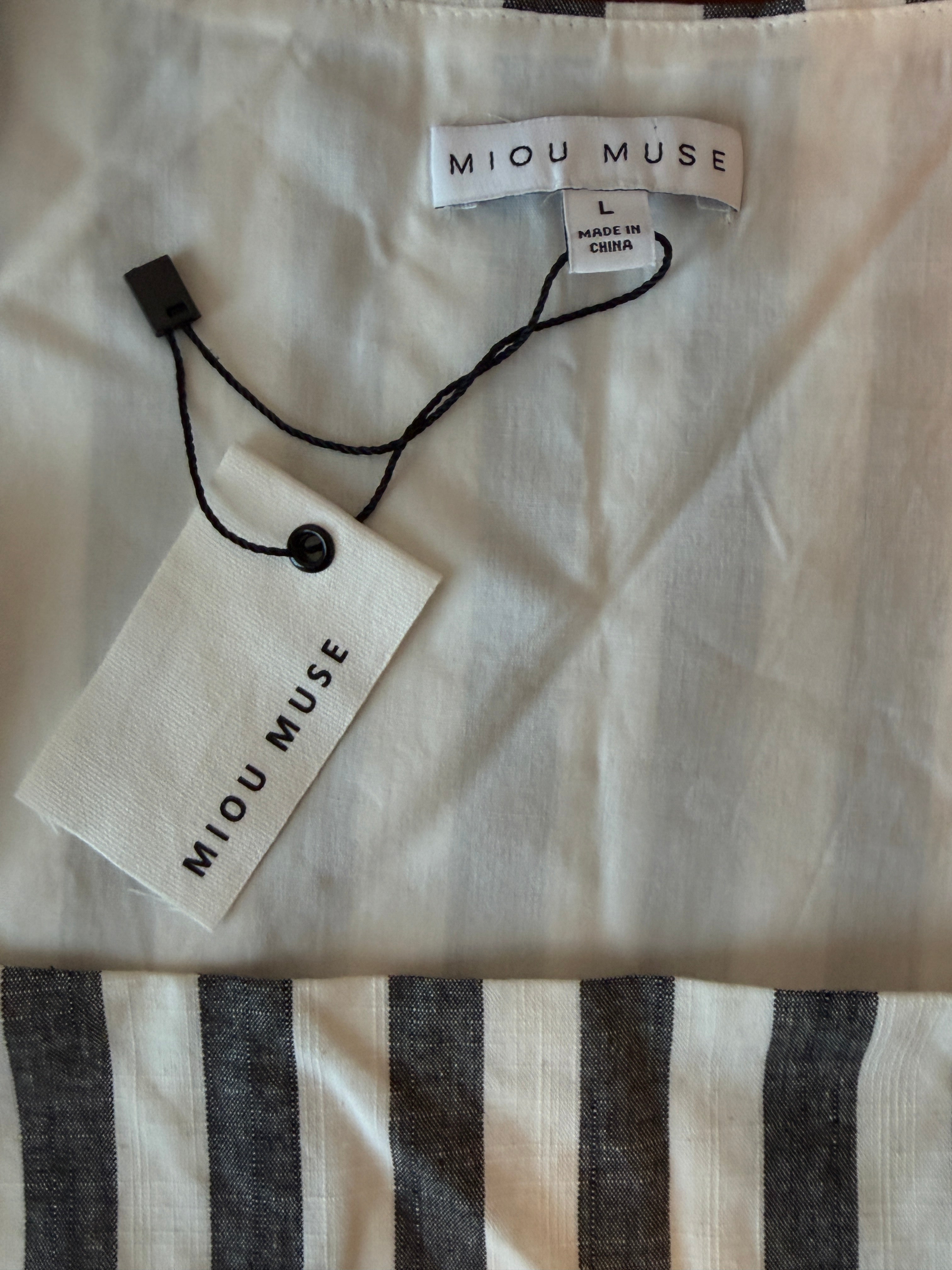 Miu Muse clothing tag on a fabric background