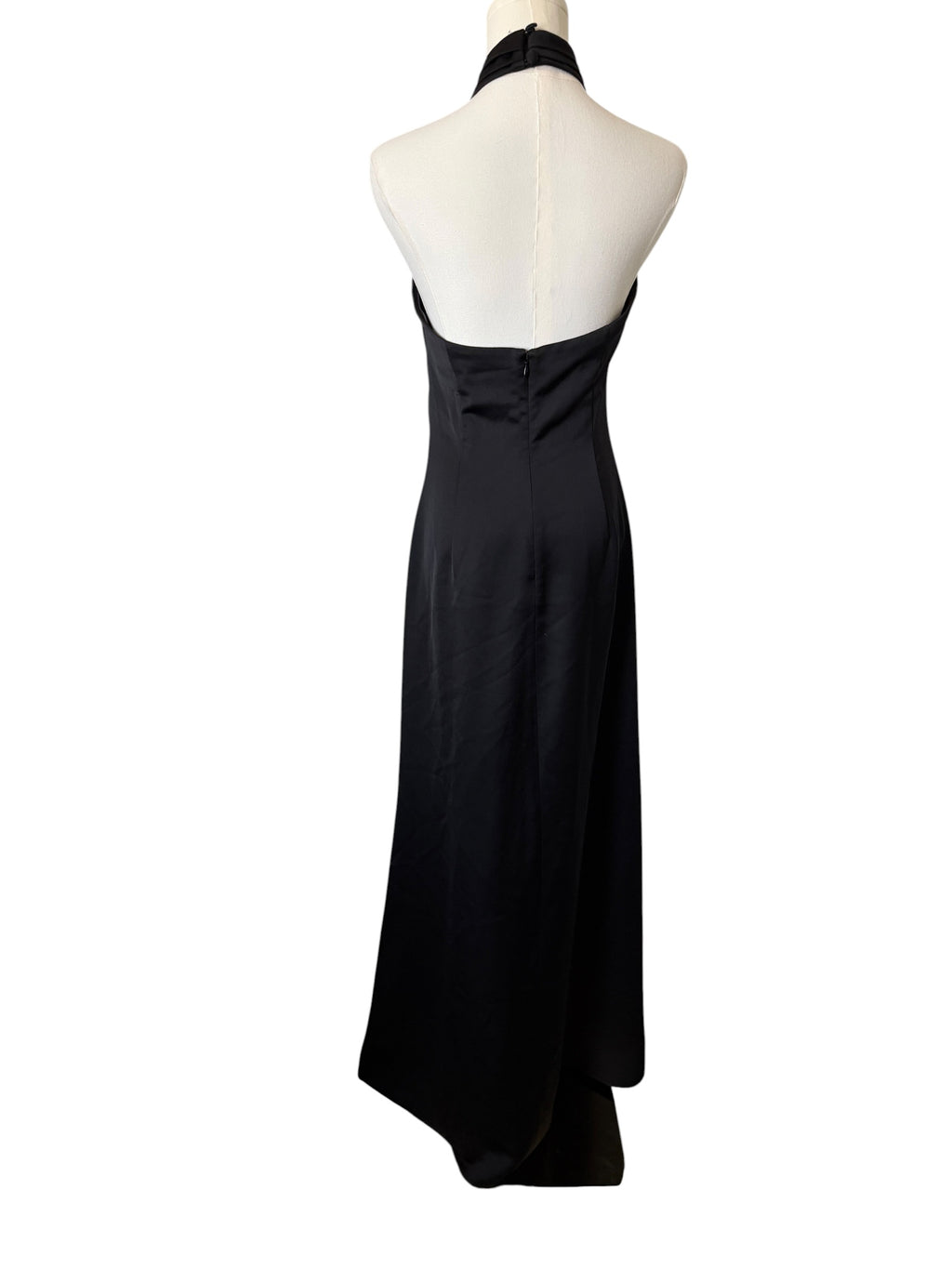 Black halter neck dress on a mannequin against a white background