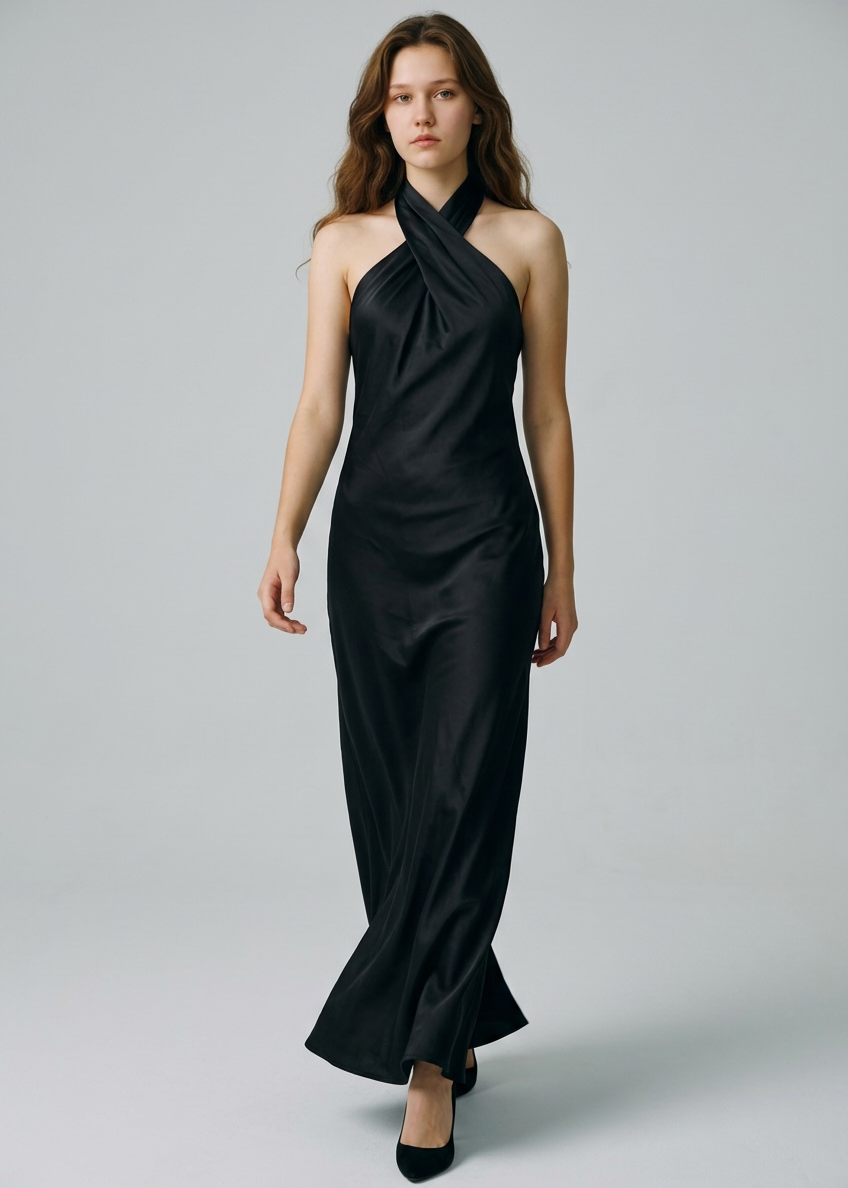 Woman wearing a black halter neck dress on a gray background