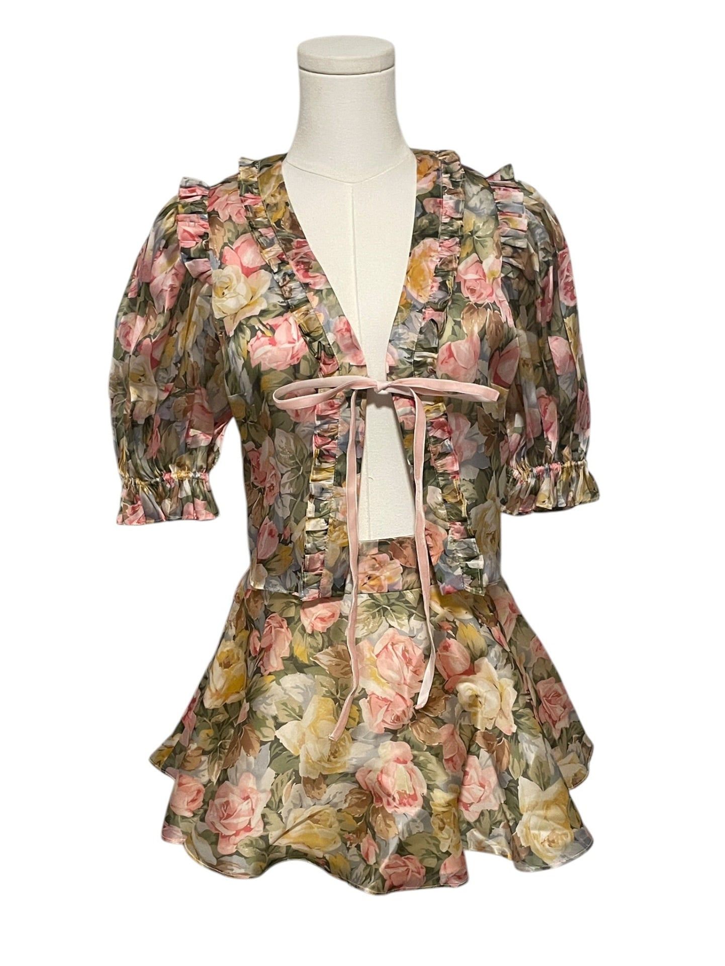 Floral dress on a mannequin against a white background