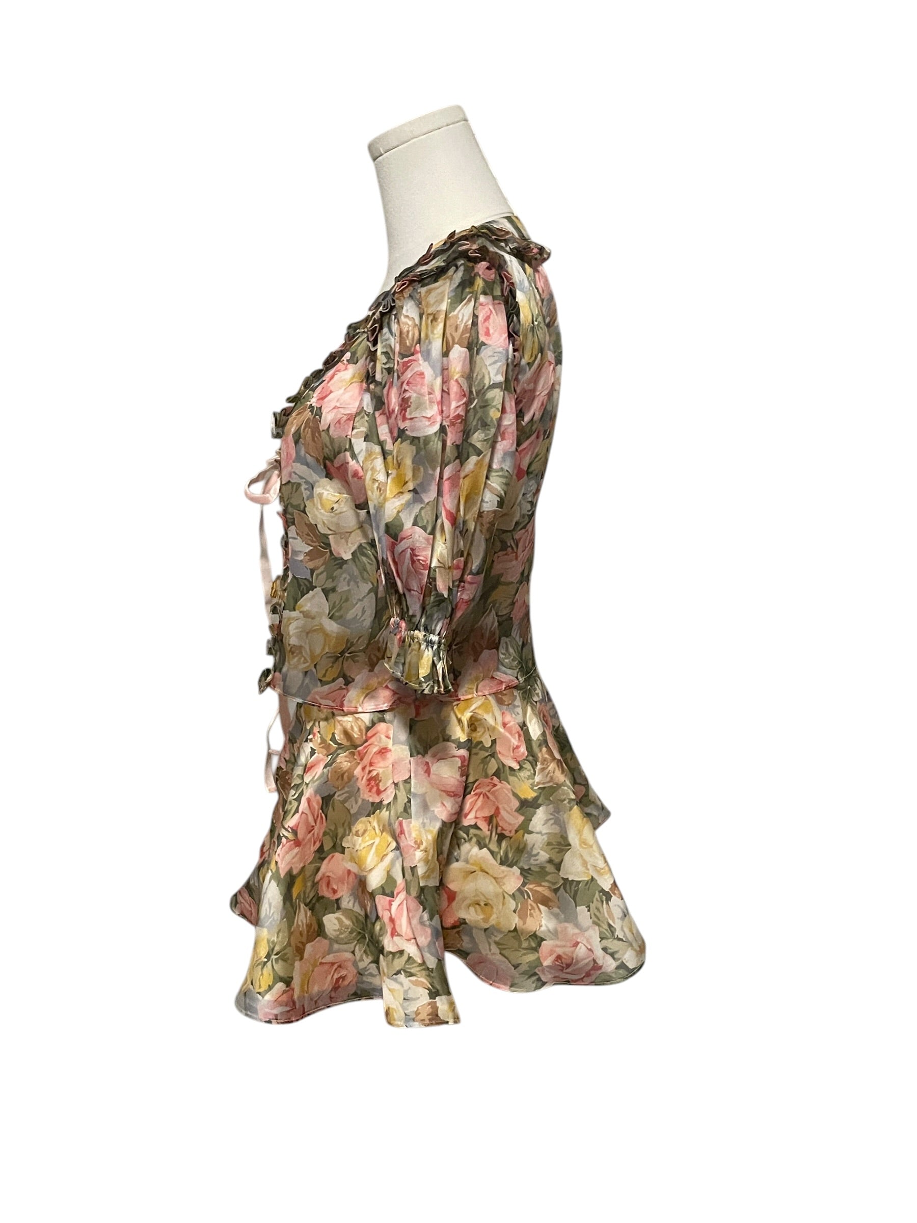 Floral dress on a mannequin against a white background