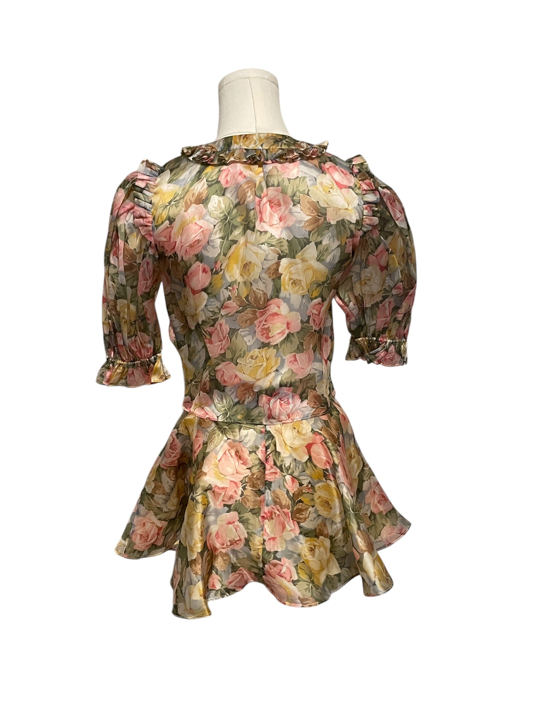 Floral dress on a mannequin against a white background