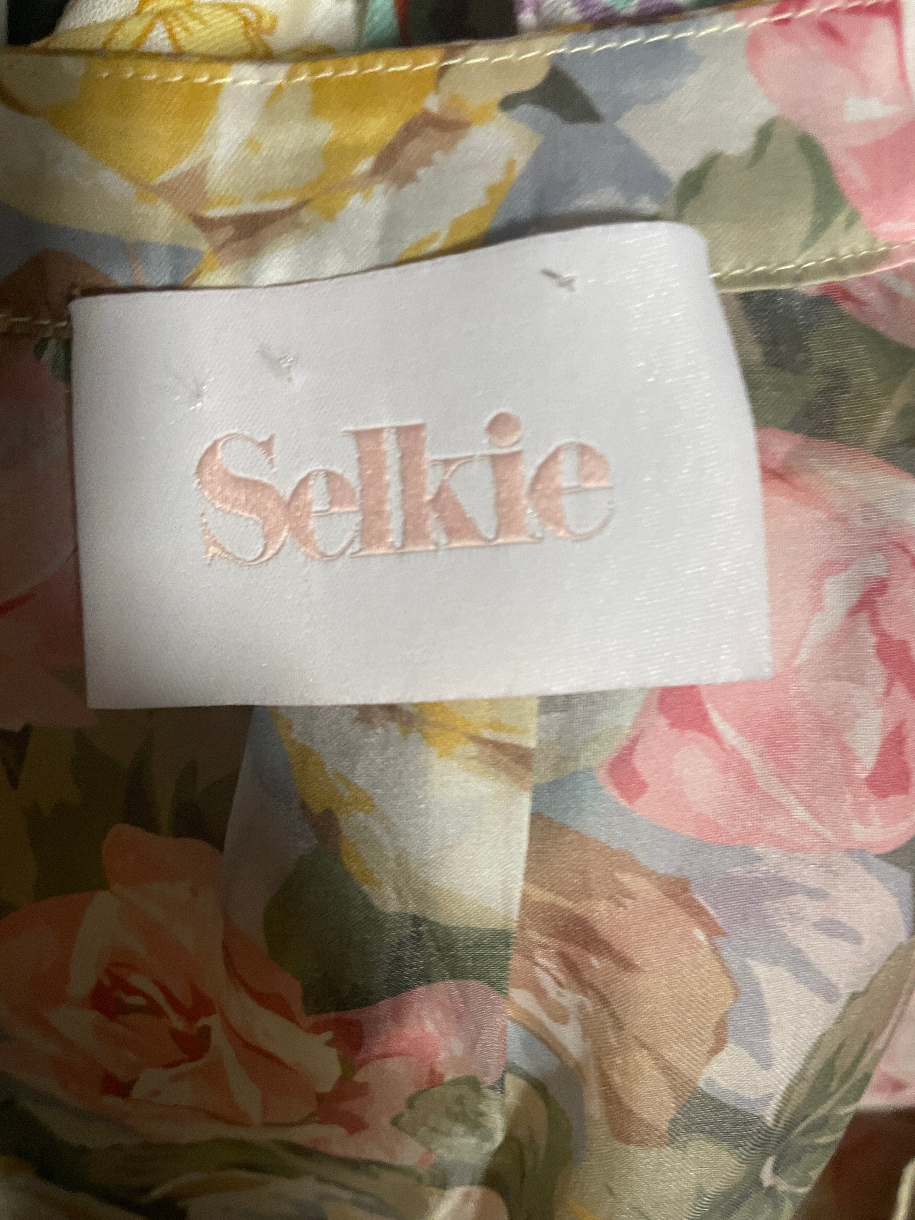 Floral fabric with a visible label featuring the brand 'Selkie'.