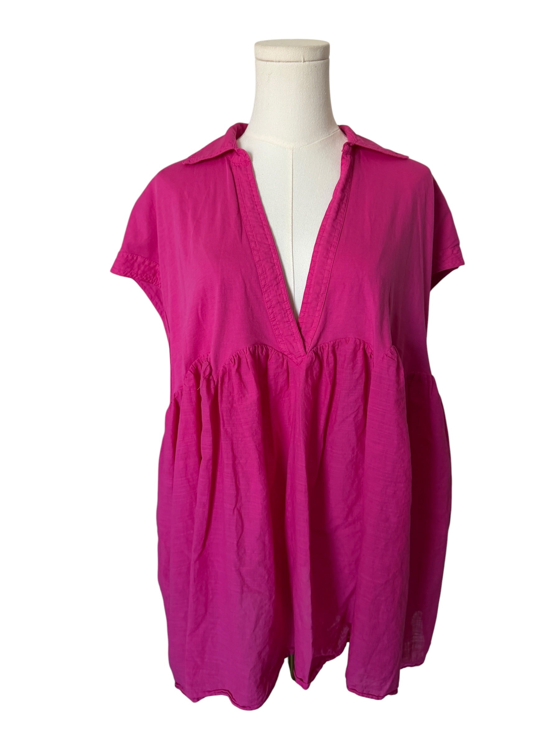 Pink dress on a mannequin against a white background