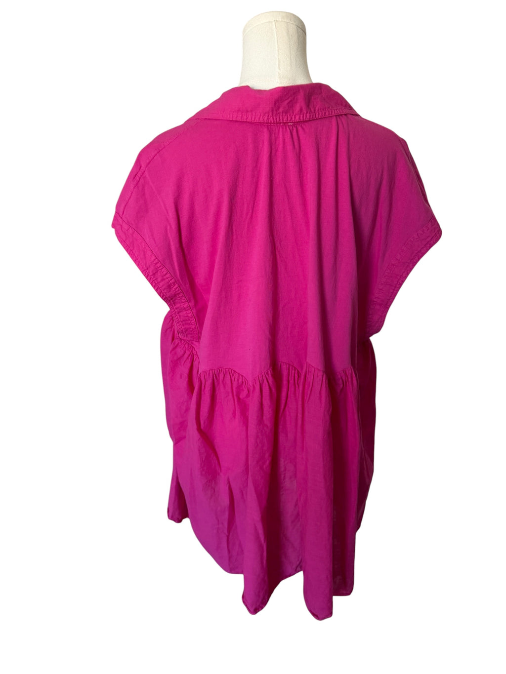 Pink dress on a mannequin against a white background